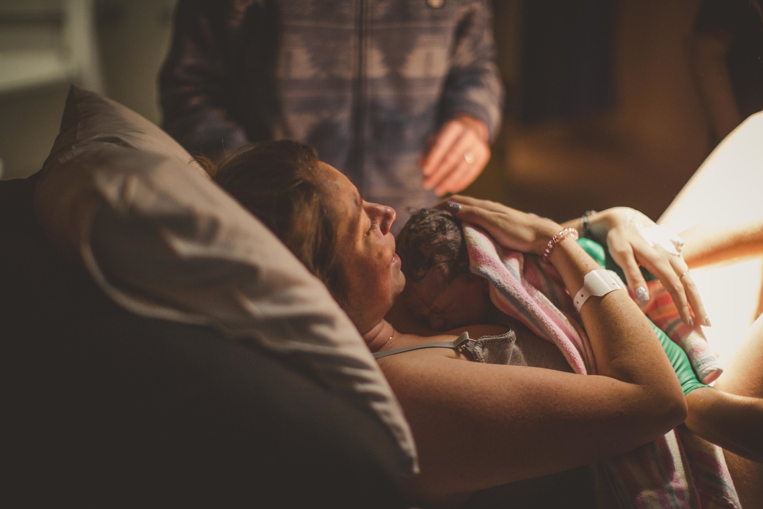 newborn resting on mother's chest after birth