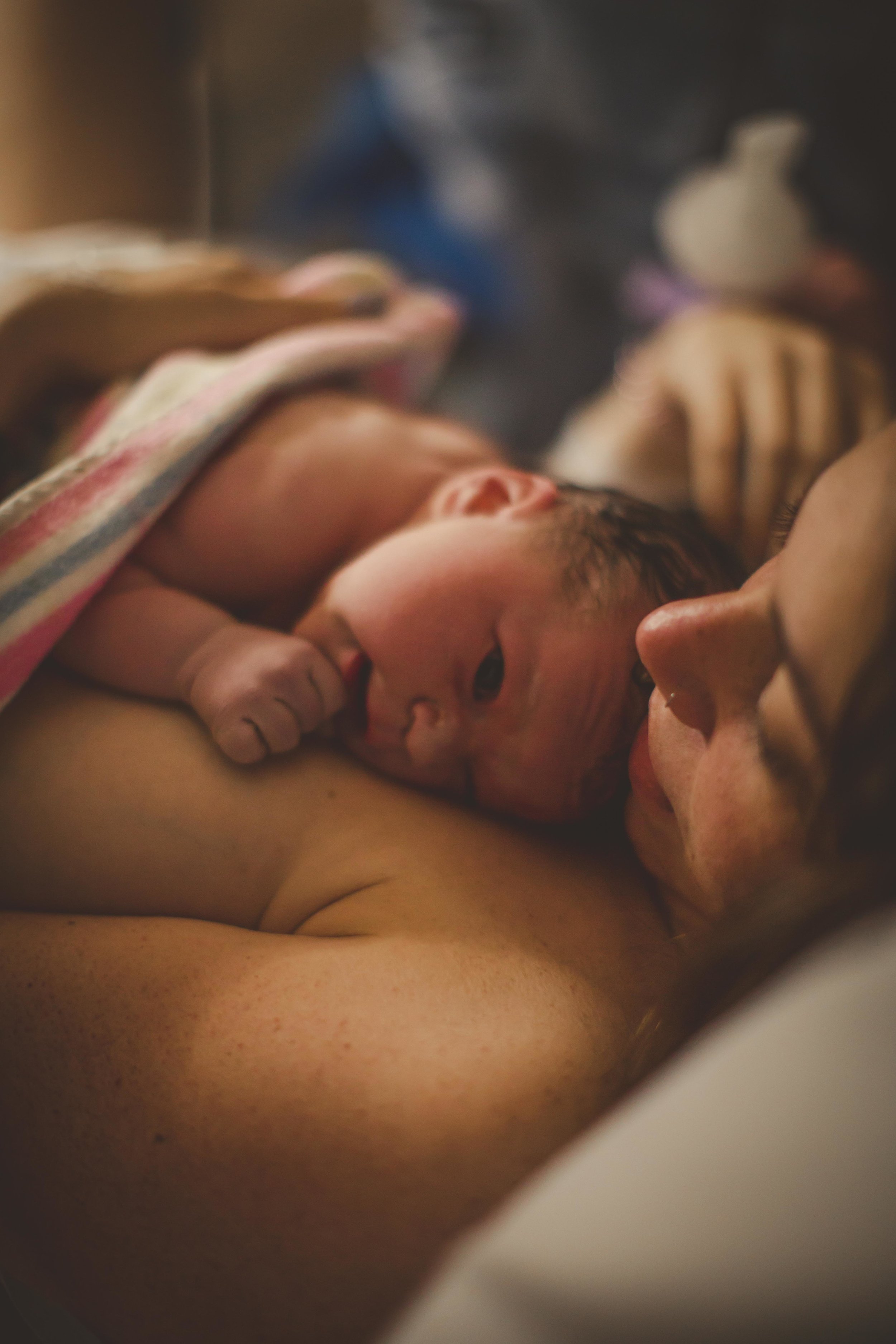 newborn resting on mother's chest after birth