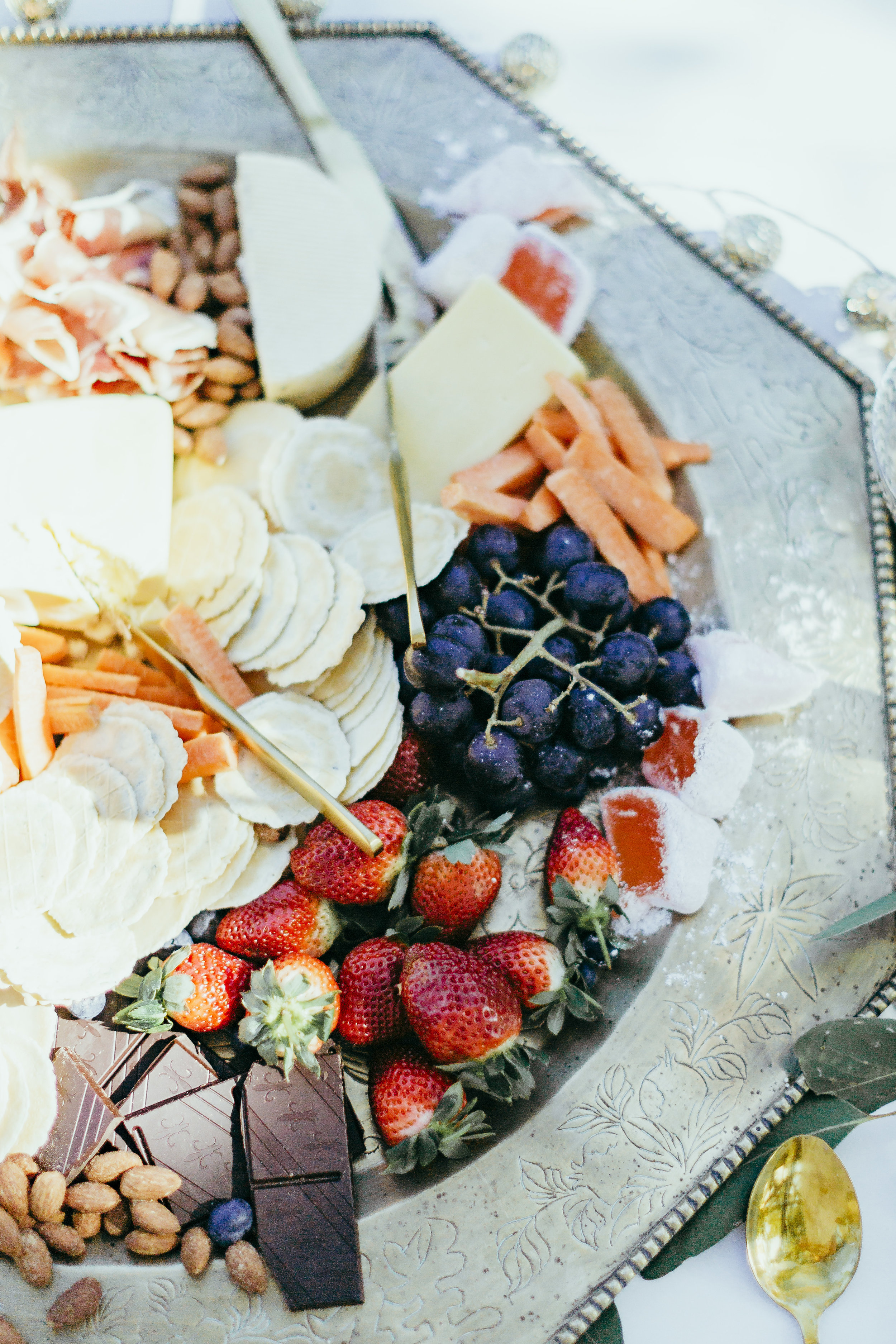 Birthday party styled with floral table settings, grazing plates, chocolate meringue, flower crowns and confetti