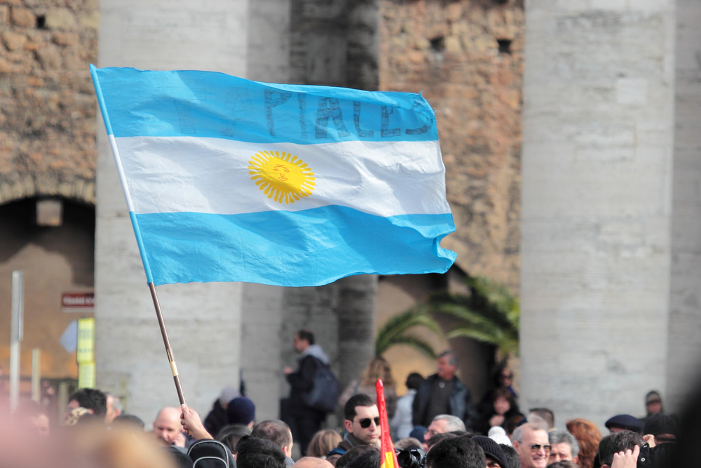 Footsteps of Pope Francis- A pilgrim waves an Argentinian flag for Pope Francis 