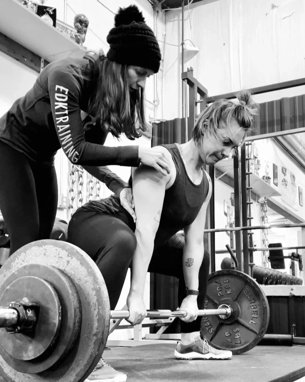 Coach Ericka Darst teaching in-person barbell technique in Minneapolis
