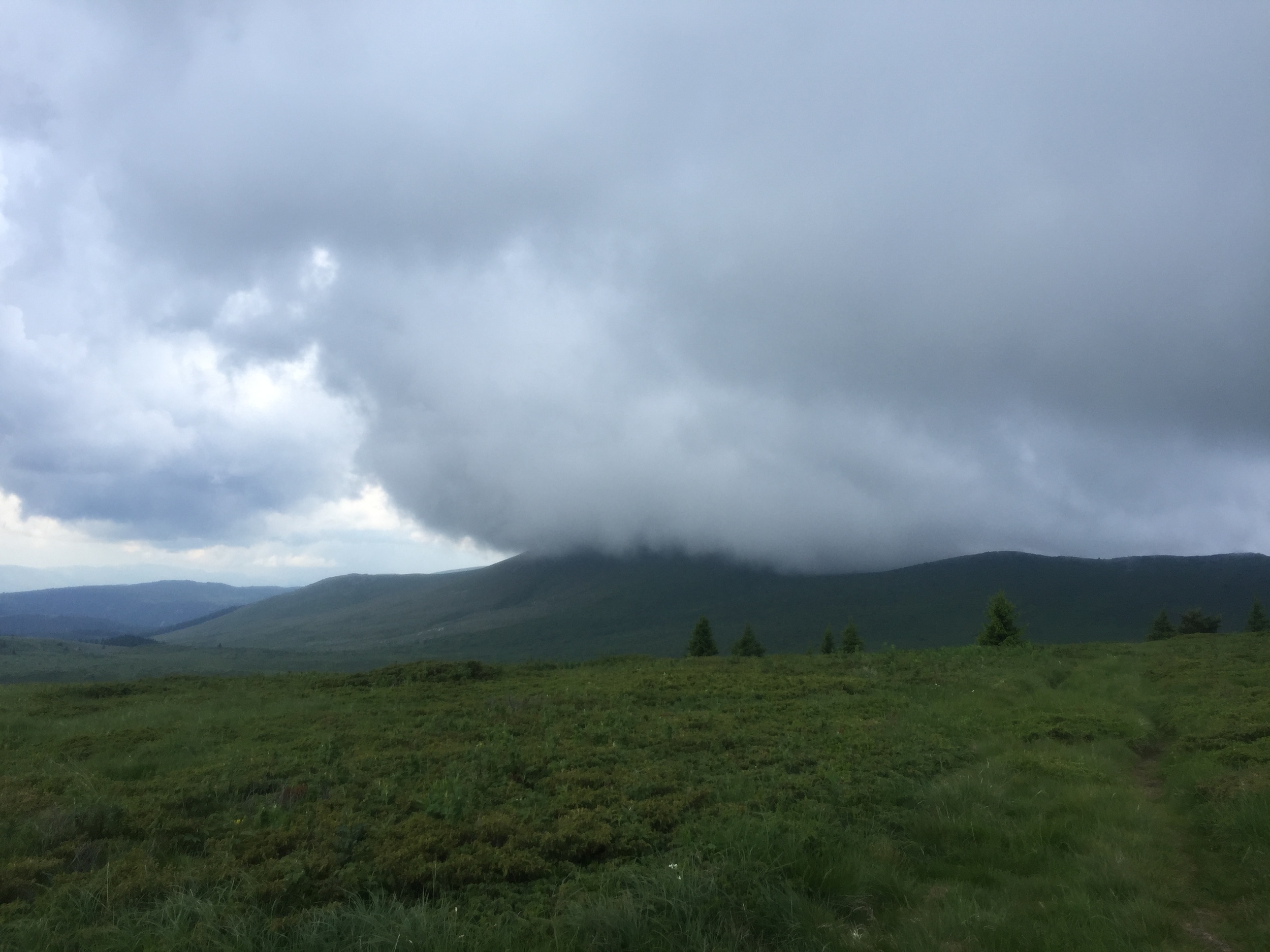 Kom Peak is somewhere in those clouds.