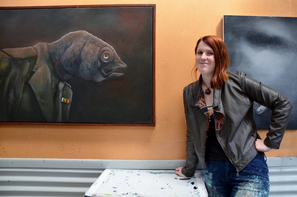 Kate with the one painting she will never part with, the Stunned Mullet as part of her PTSD body of work from 2013.