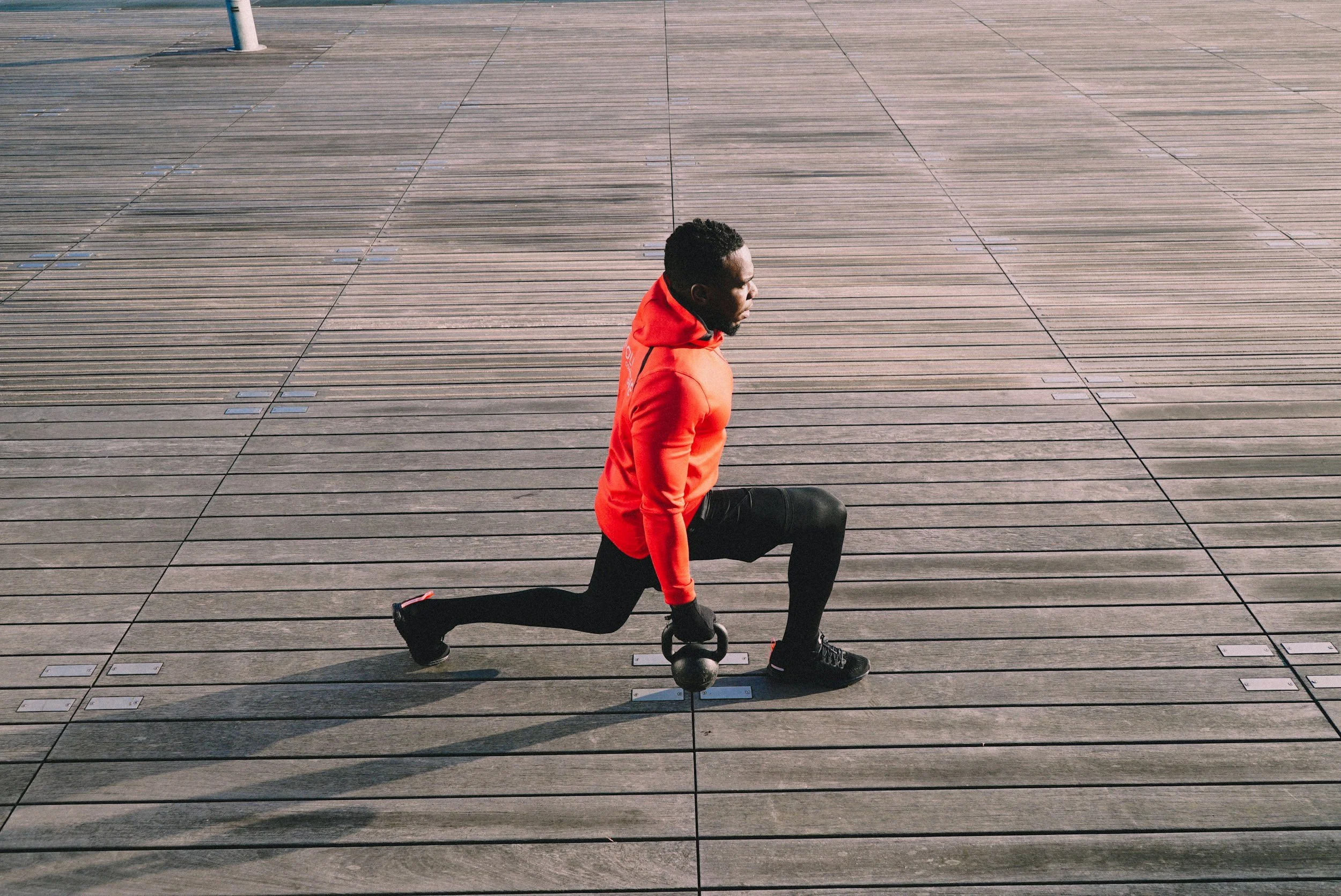 Reverse lunge with knee drive exercise for lower body strength and fat loss workout in Clapham