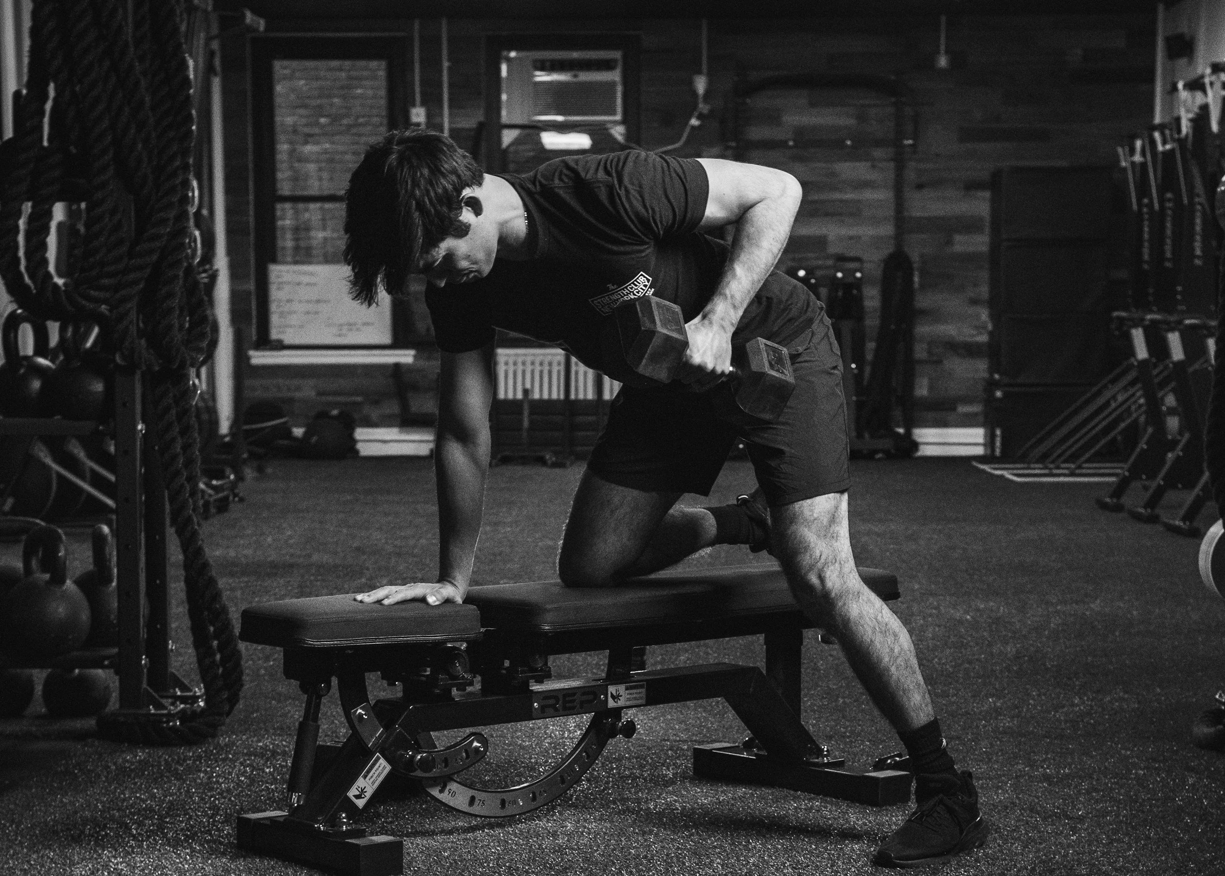 Bent over dumbbell row exercise for back strength and posture in Clapham full body workout