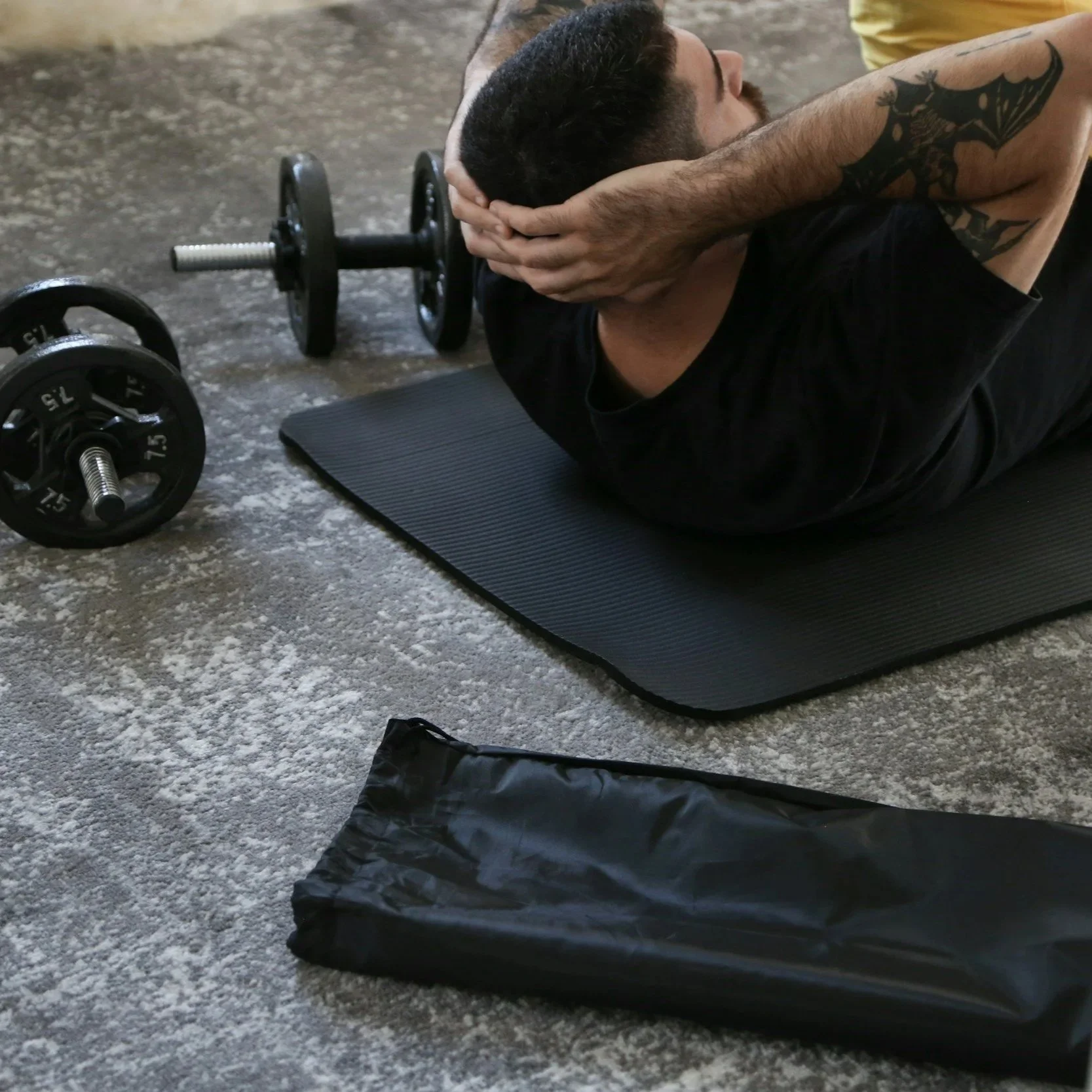 Man doing a crunch exercise at home during a personal training session in South Kensington