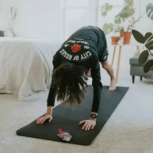 Woman doing an in-home personal training session with dumbbells in her Nine Elms SW8 apartment — mobile personal trainer bringing the gym to you