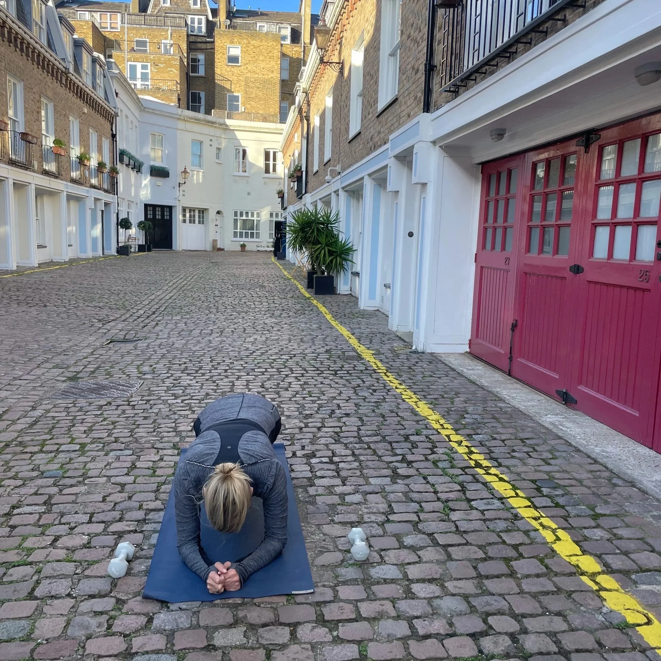 Personal trainer in South Kensington guiding client through strength training and mobility exercises