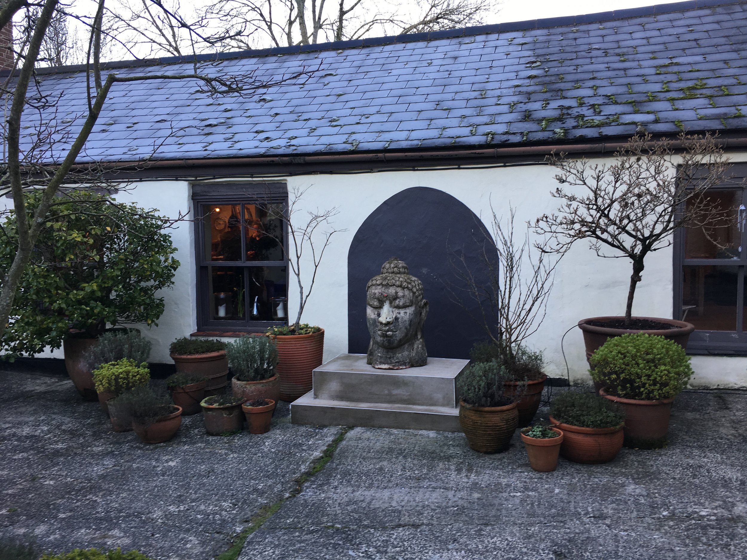 The courtyard entrance to the main farmhouse at Yeotown, where Eastern traditions meet rustic charm 