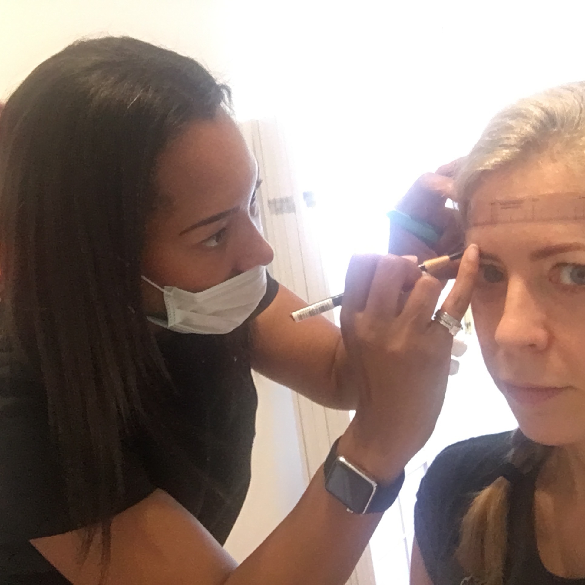 Sian Dellar, eyebrow microblading expert, first measures up my brows