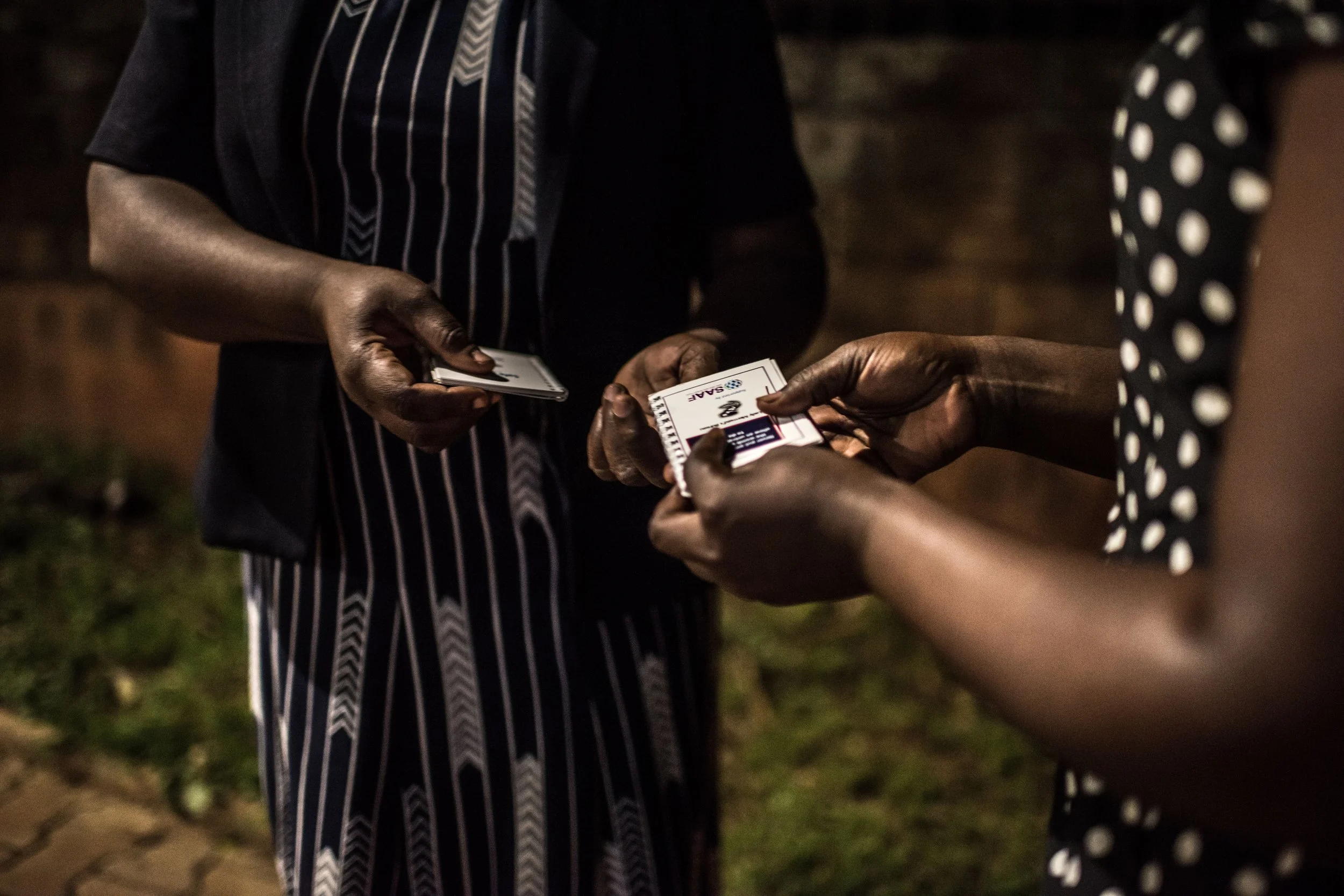 Lady Mermaid's Bureau project officer Noor Nakigozi gives out a booklet on safe abortion developed with support from the SAAF secretariat to Deborah, a sex worker in Kampala.