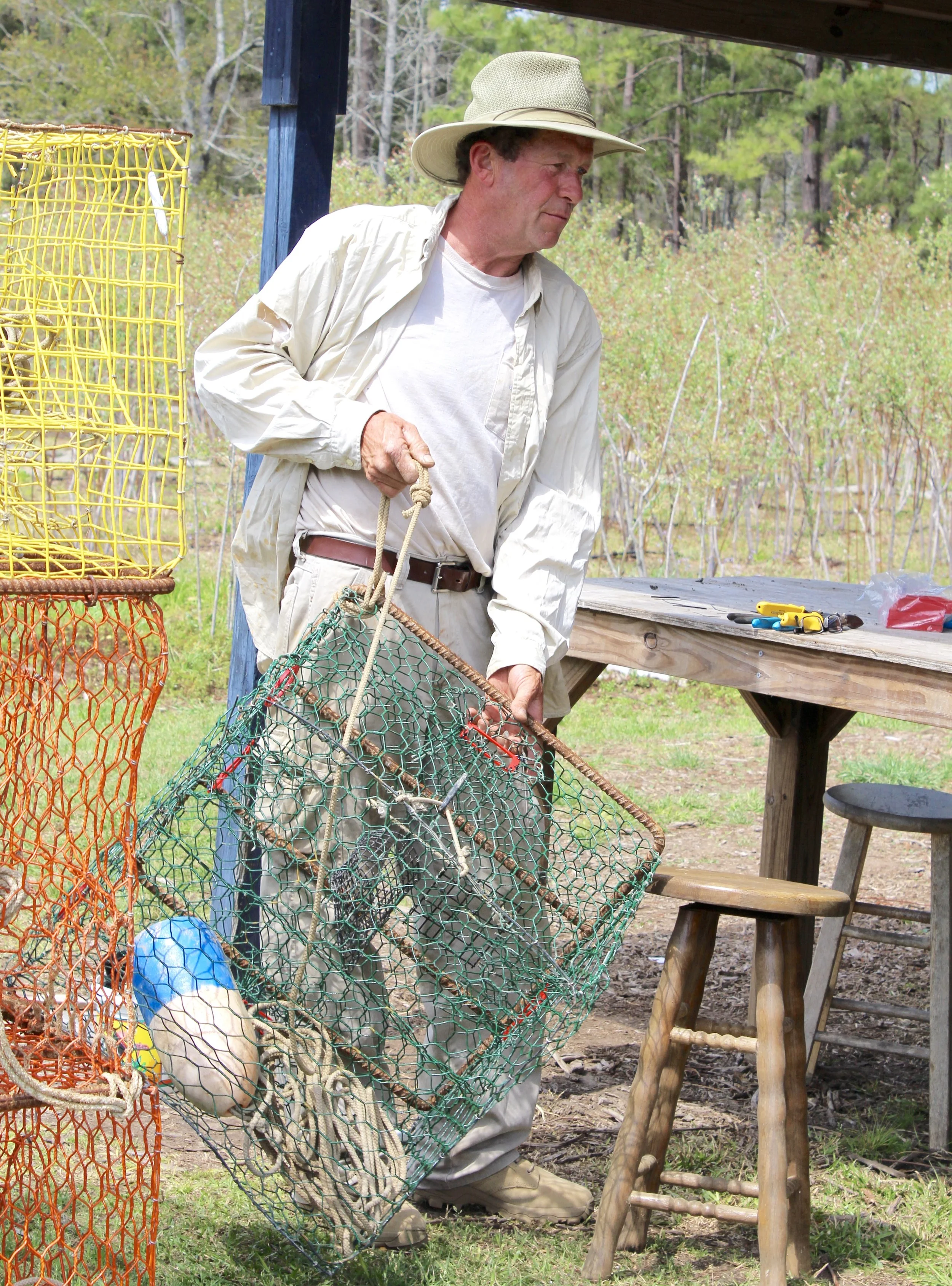 Crabber Robert Sollot finishes installing four bycatch reduction devices (BRDs) on one of his 120 crab traps. (Photo: E. Weeks/SCDNR)