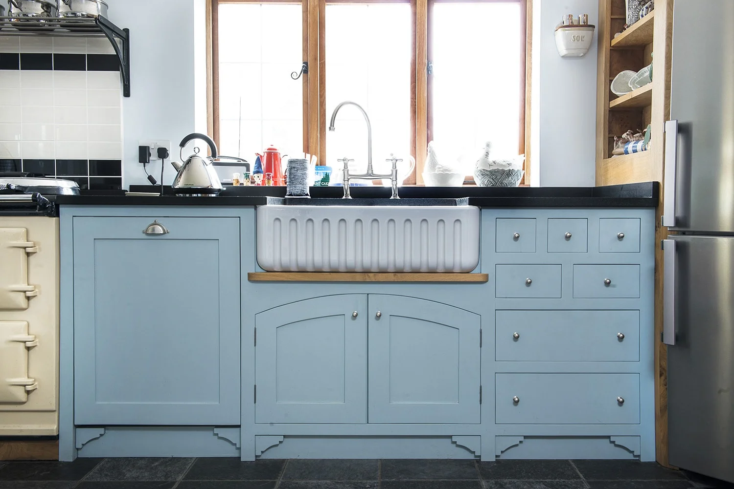 Blue kitchen cabinets with embedded Ribchester sink