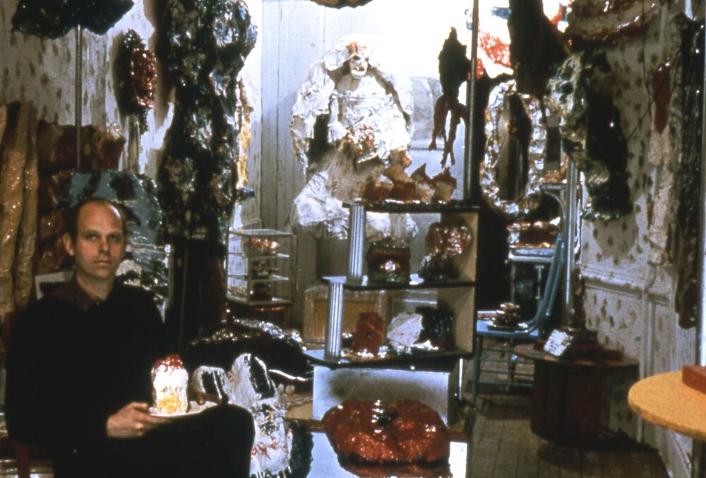 Claes Oldenburg sitting in "The Store" (1961)