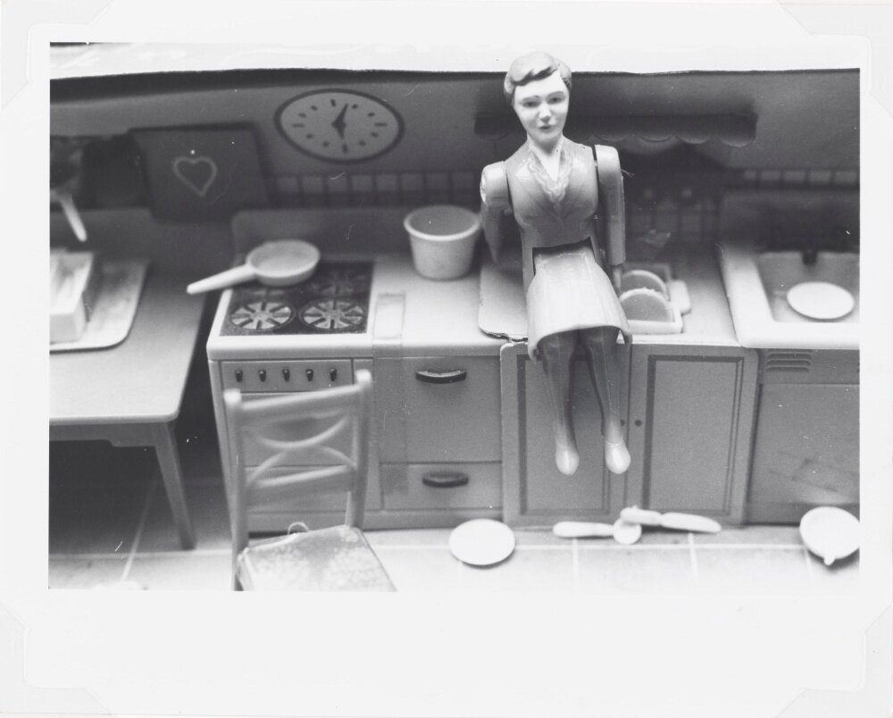 Laurie Simmons, “Woman / Kitchen / Sitting on Sink” (1976)