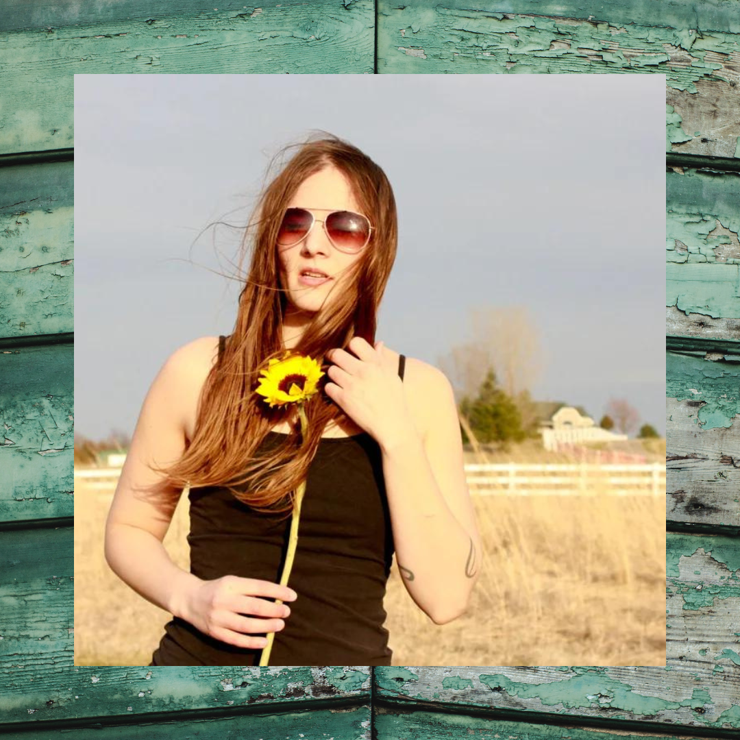 Woman wearing sunglasses holding Sunflower