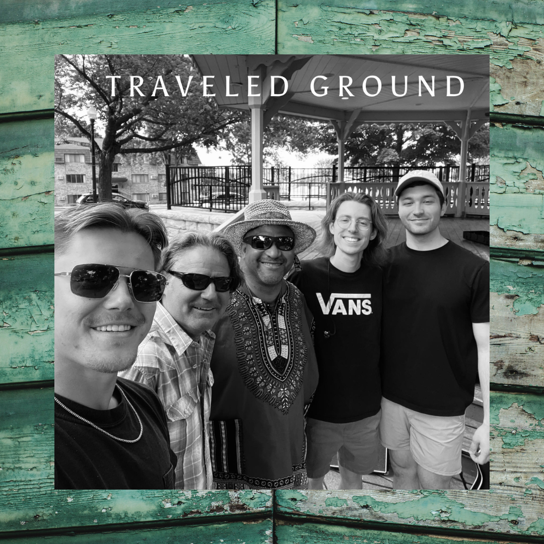 5 men smiling in front of a gazebo