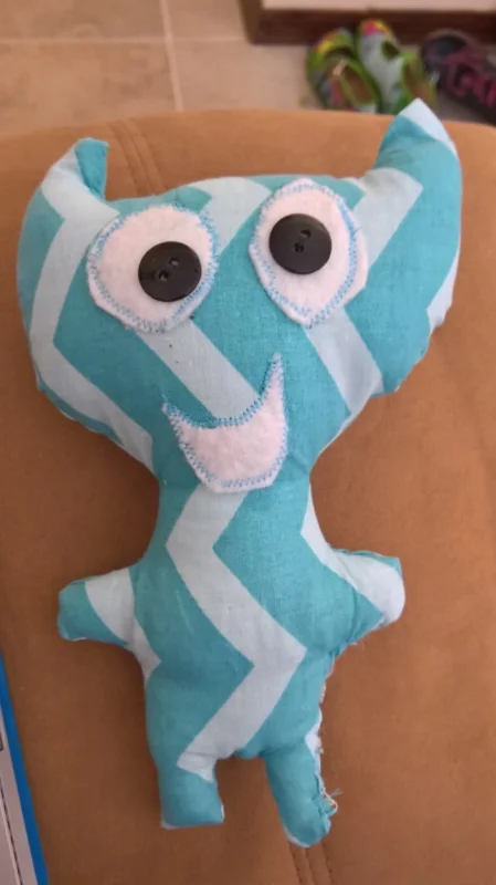 The blue one is prototype #1, he has some problems, namely the stitches around the eyes and mouth. I don't have the right presser foot to apply appliques, so I was trying to eyeball it and that didn't go well at all. I have decided to sew those on by hand from now on.