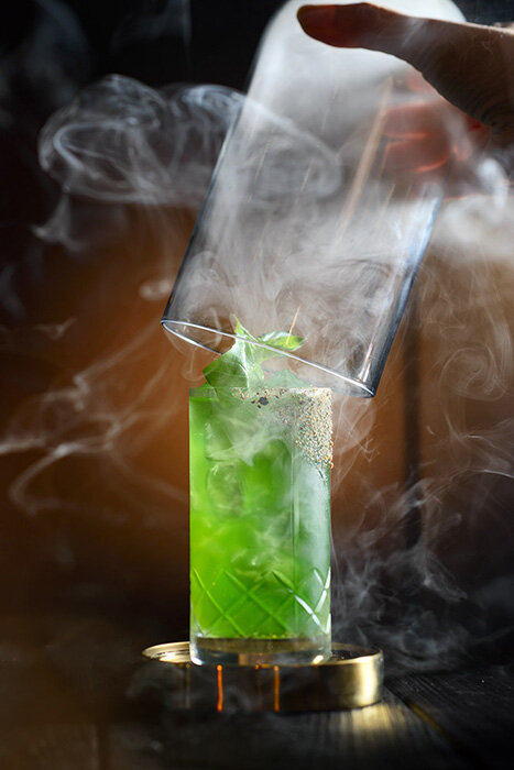 green cocktail beverage with smoke