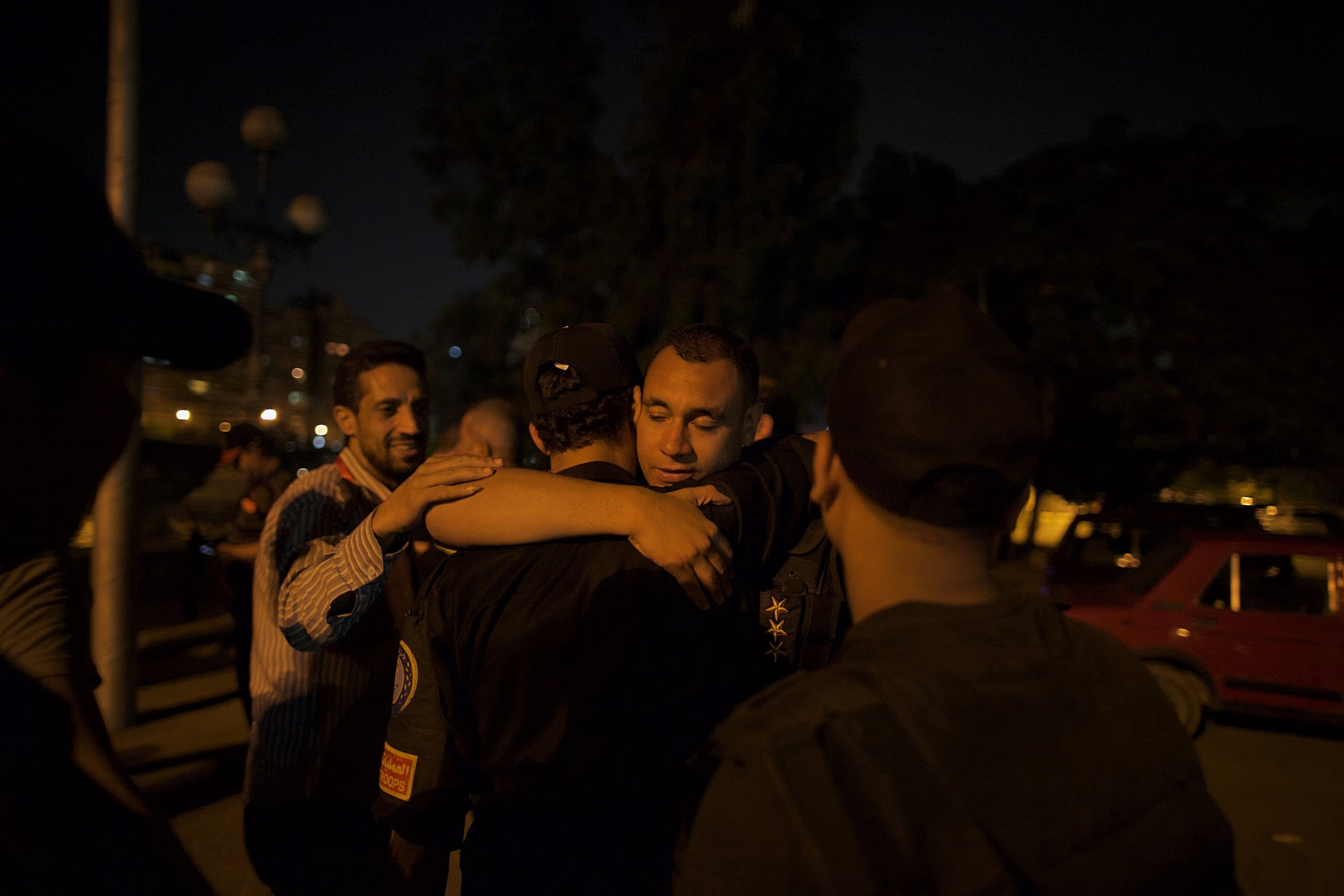 Just outside Tahrir Square, members of Egyptian security services embrace moments after the military deposed Mohammed Morsi and installed Gen. Abdel Fattah el-Sisi as president. 
