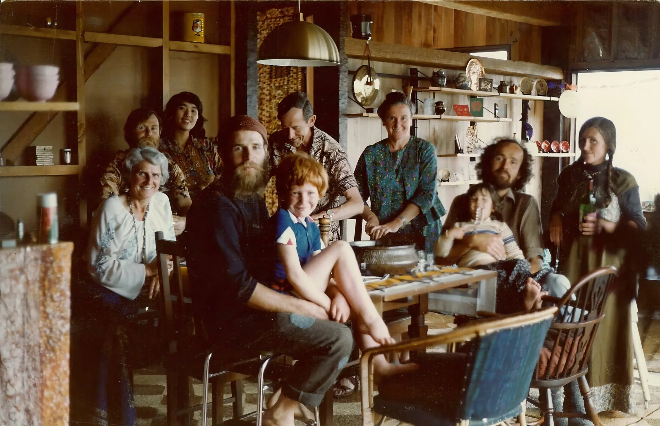 A vintage family photo of relatives around a kitchen table, ready for a funeral slideshow by UK Funeral Video Services