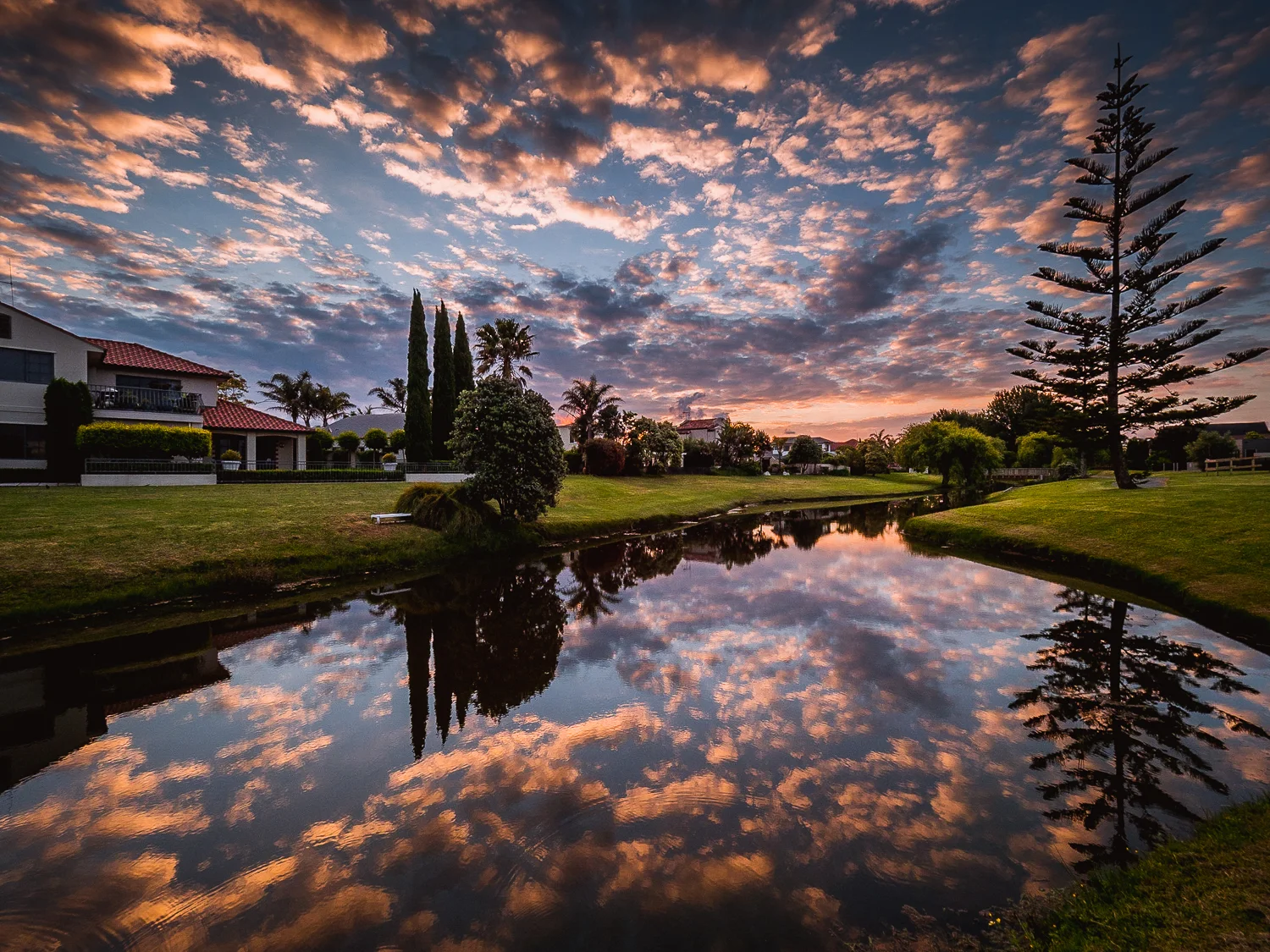Above and below. Sunset at the end of my street. Olympus M.Zuiko 7-14mm f/2.8 lens.