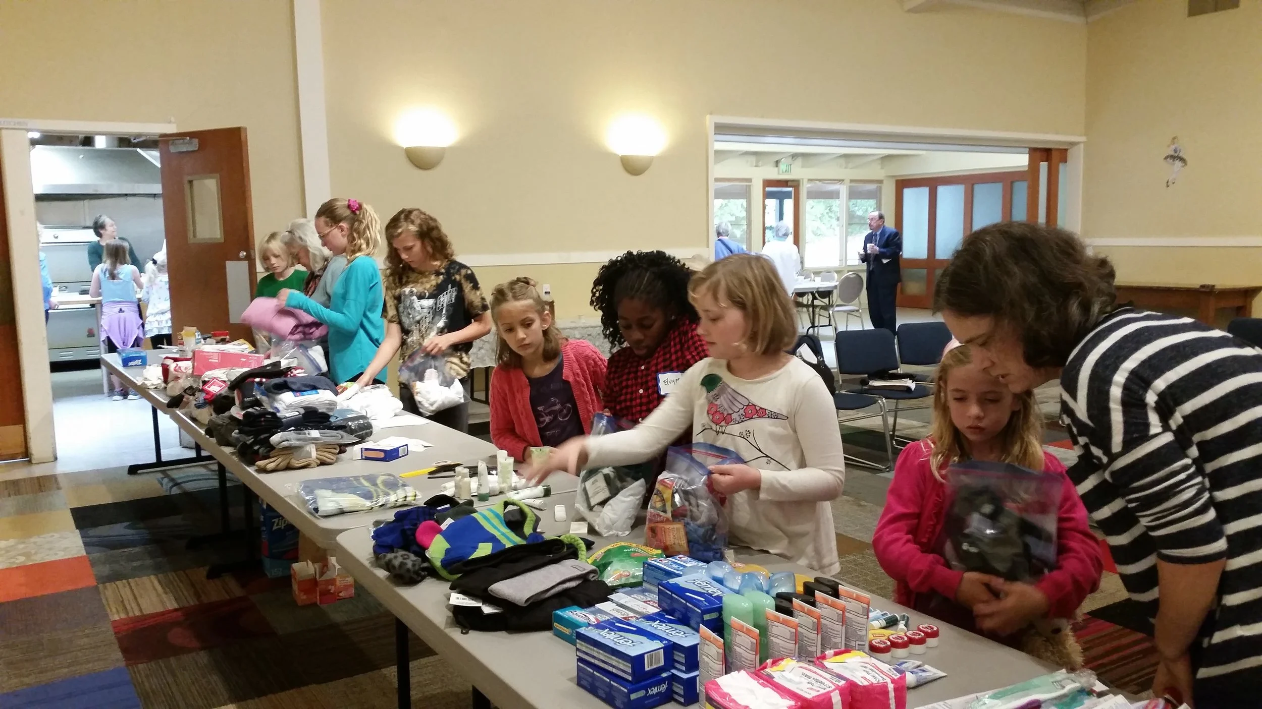 Children and Youth helping pack "Blessing Bags" to hand out to people in need in our communities
