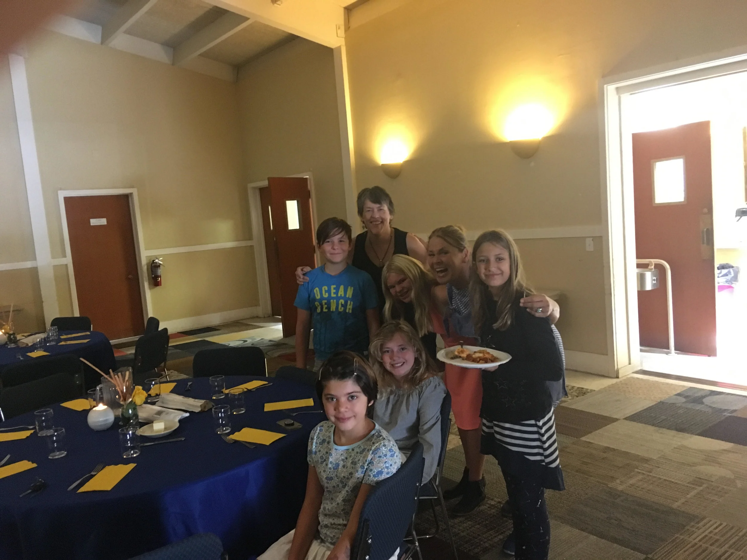 Children helped decorating tables for a church meeting.