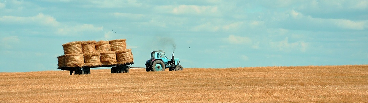 Rancher moves straw bails off of Montana ranch