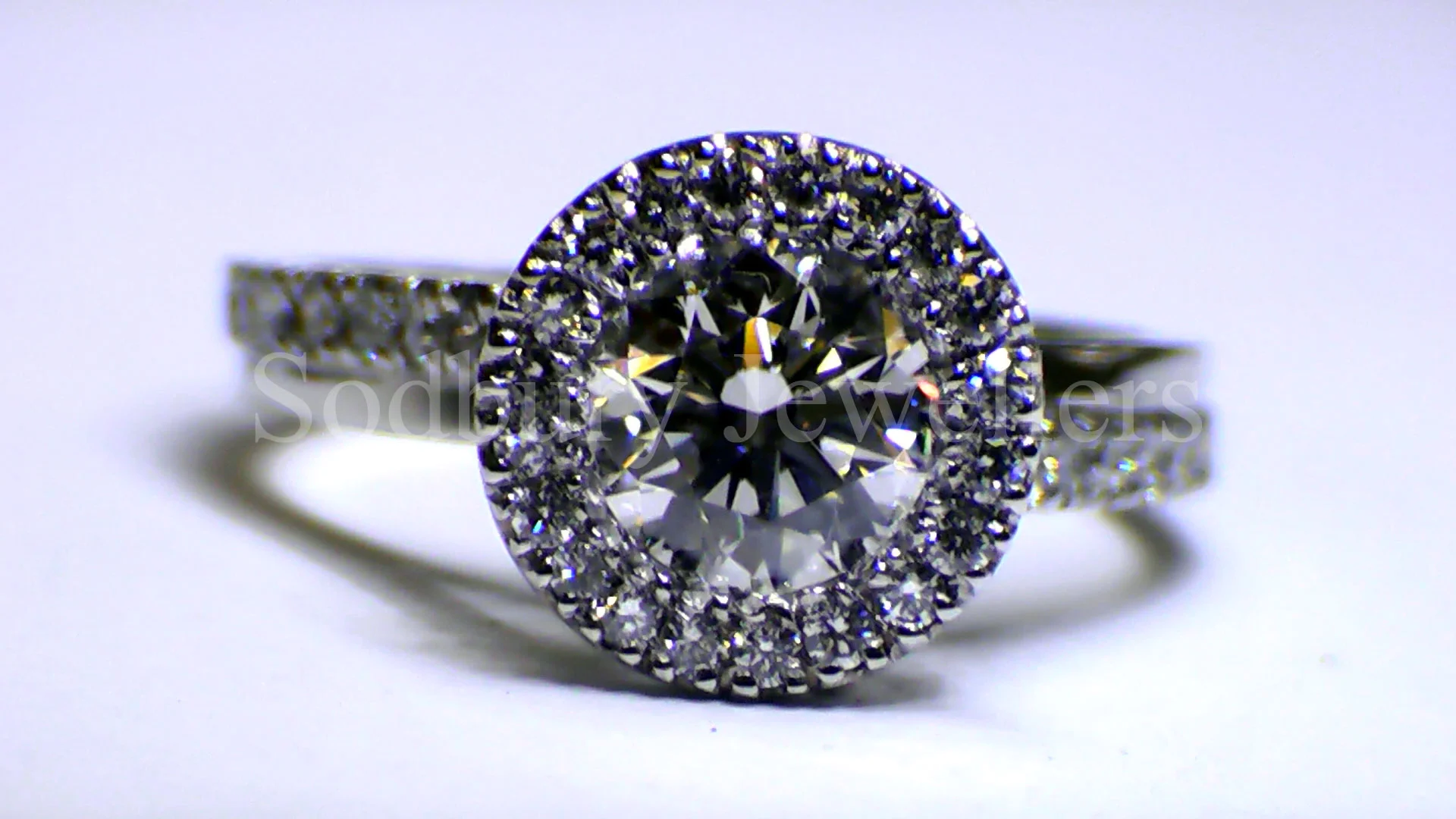 A Diamond Halo ring with Diamond set shoulders.