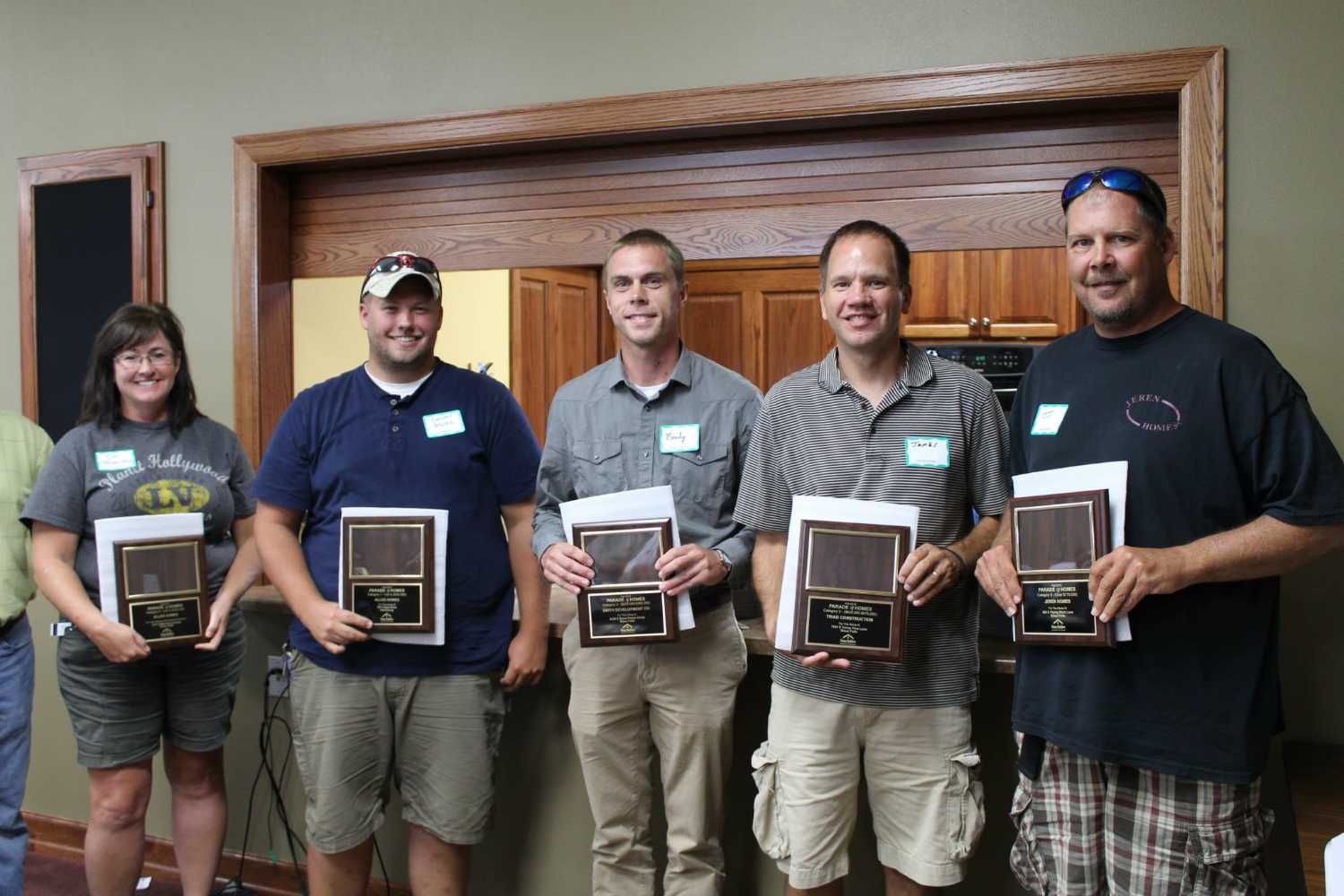 Brady Smith (middle) accepts an Award of Excellence in the Single Family Home Category of the 2015 Fall Parade of Homes.