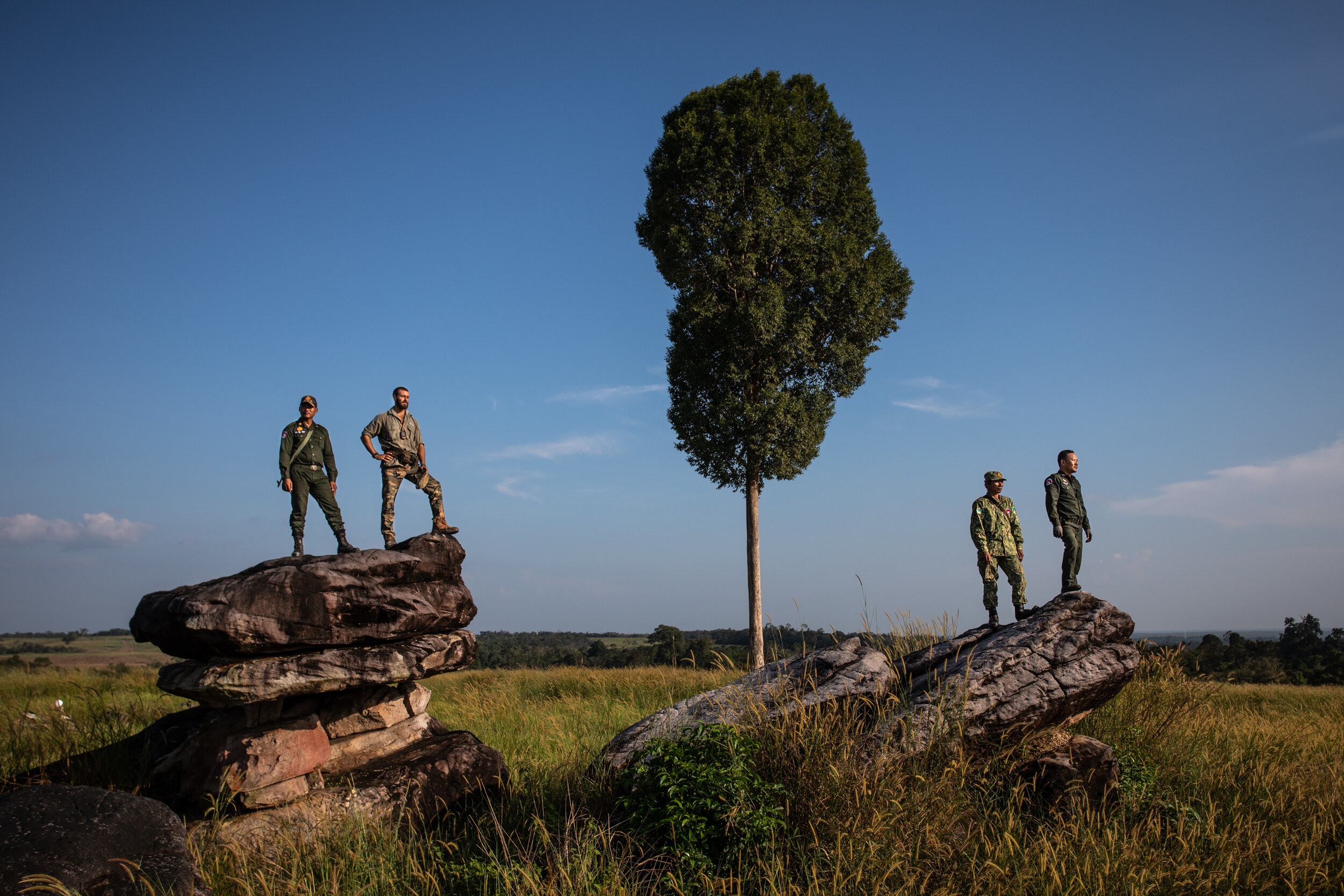  Wildlife Alliance rangers pose for a portrait during a break halfway through a daily patrol. 