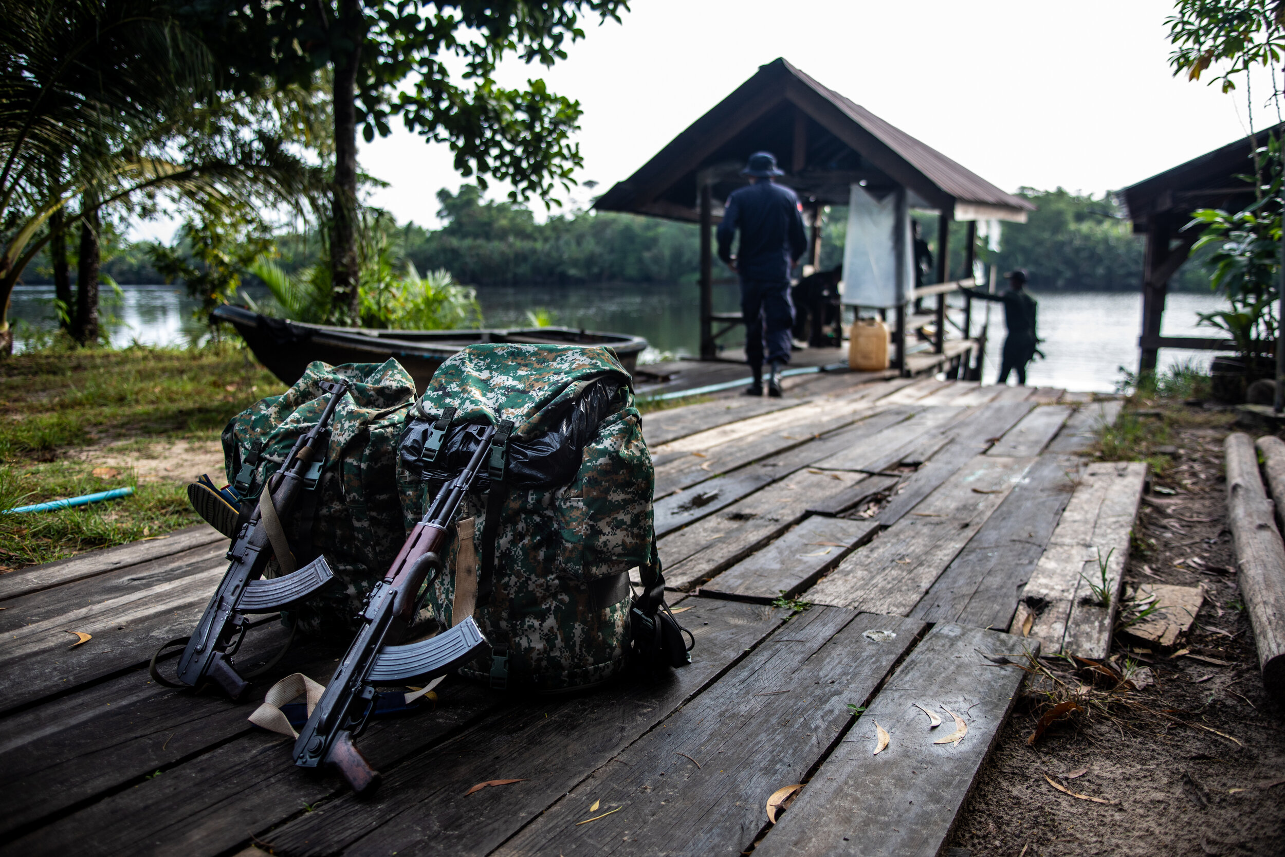  Rangers prepare their 2 day long patrol packs and guns at Stung Proat Station station before putting them in a boat and heading far up river to the drop off point.   The rangers carry the least amount of weight possible for the ease walking off trai