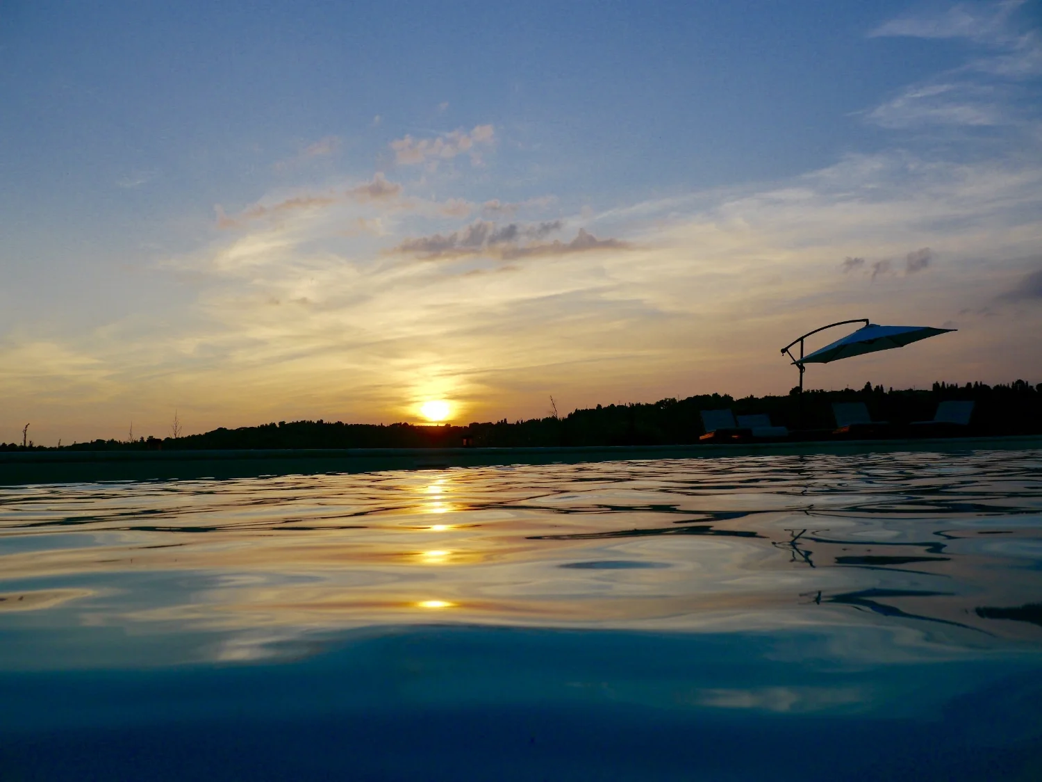 large tuscan pool at sunset