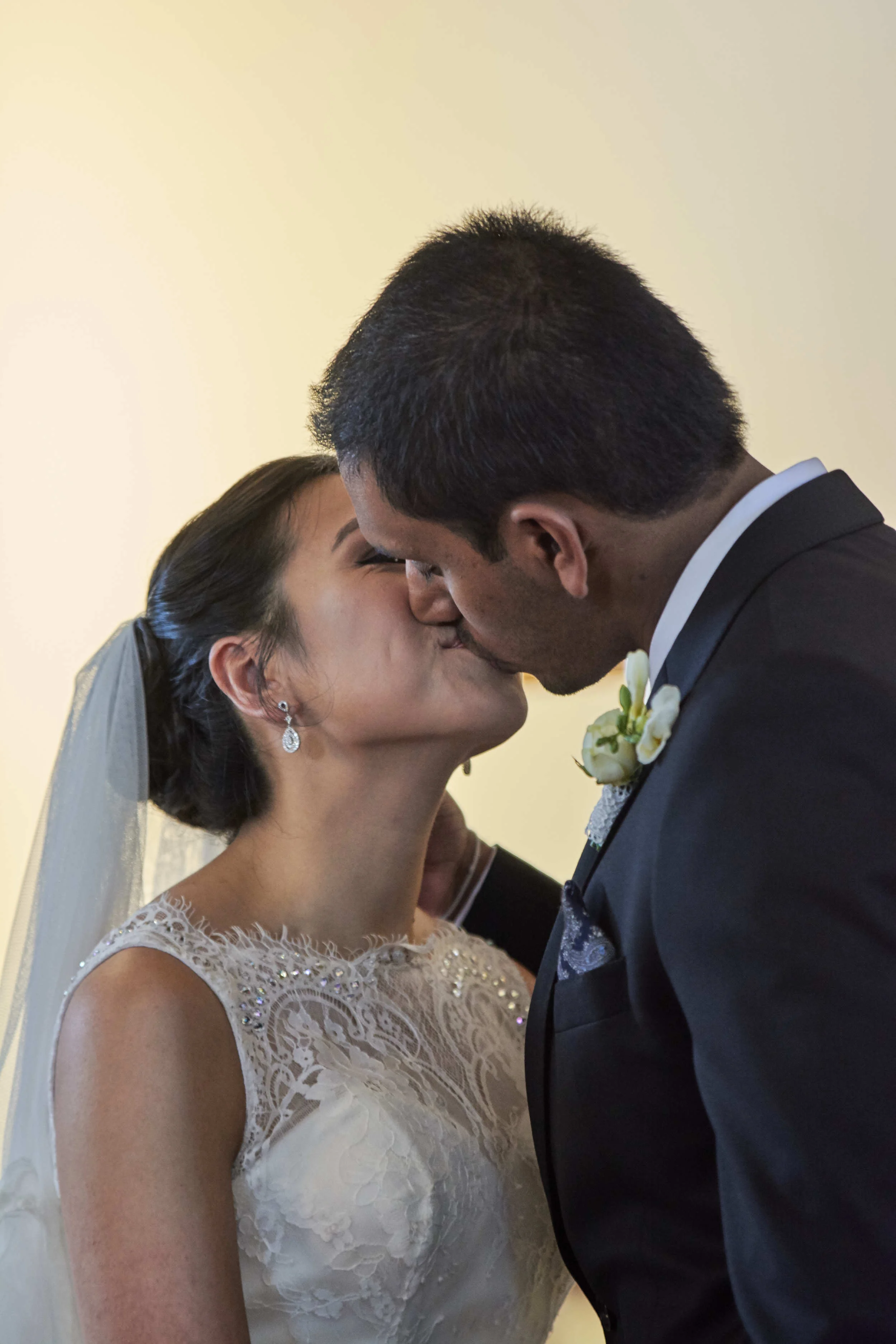 Bride and groom kissing during wedding ceremony in Melbourne, Australia
