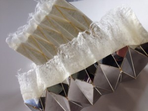 Contrast of hard geometry with diaphanous felt.