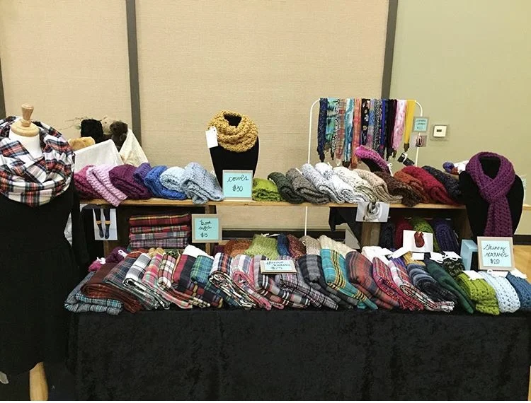 Macy and her cozy creations set up for market