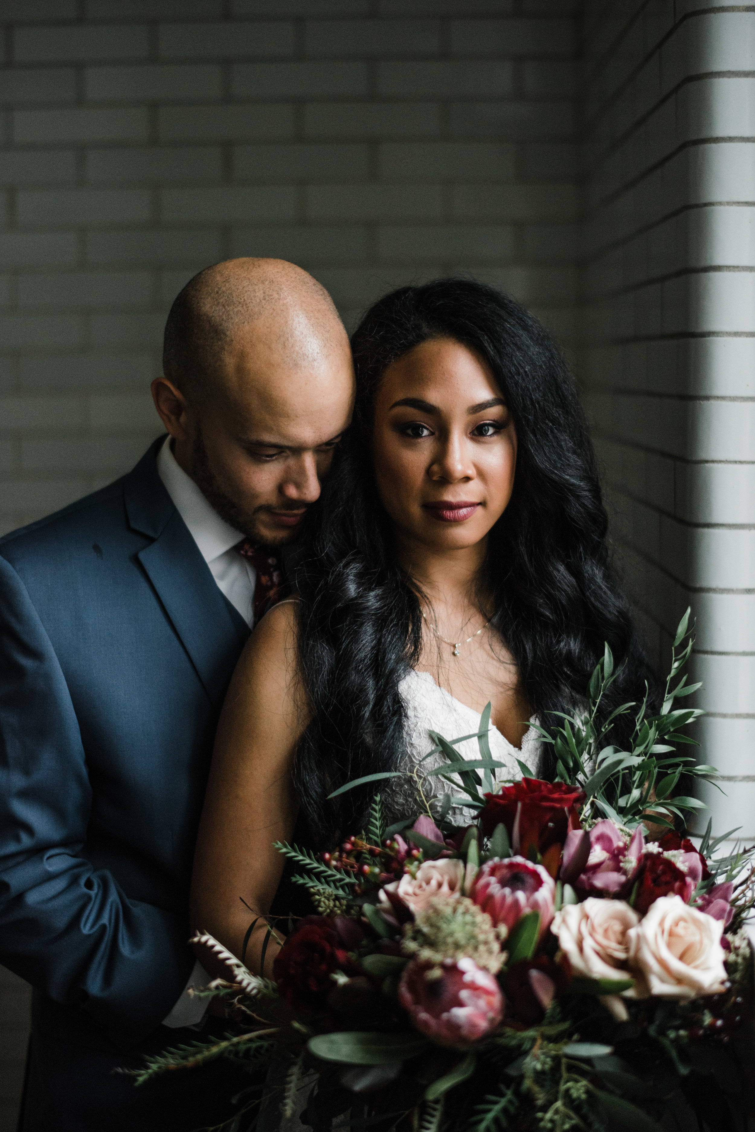  Wedding portrait of bride and groom with protea and roses. Des Moines, IA. Photographed by Austin Day. 