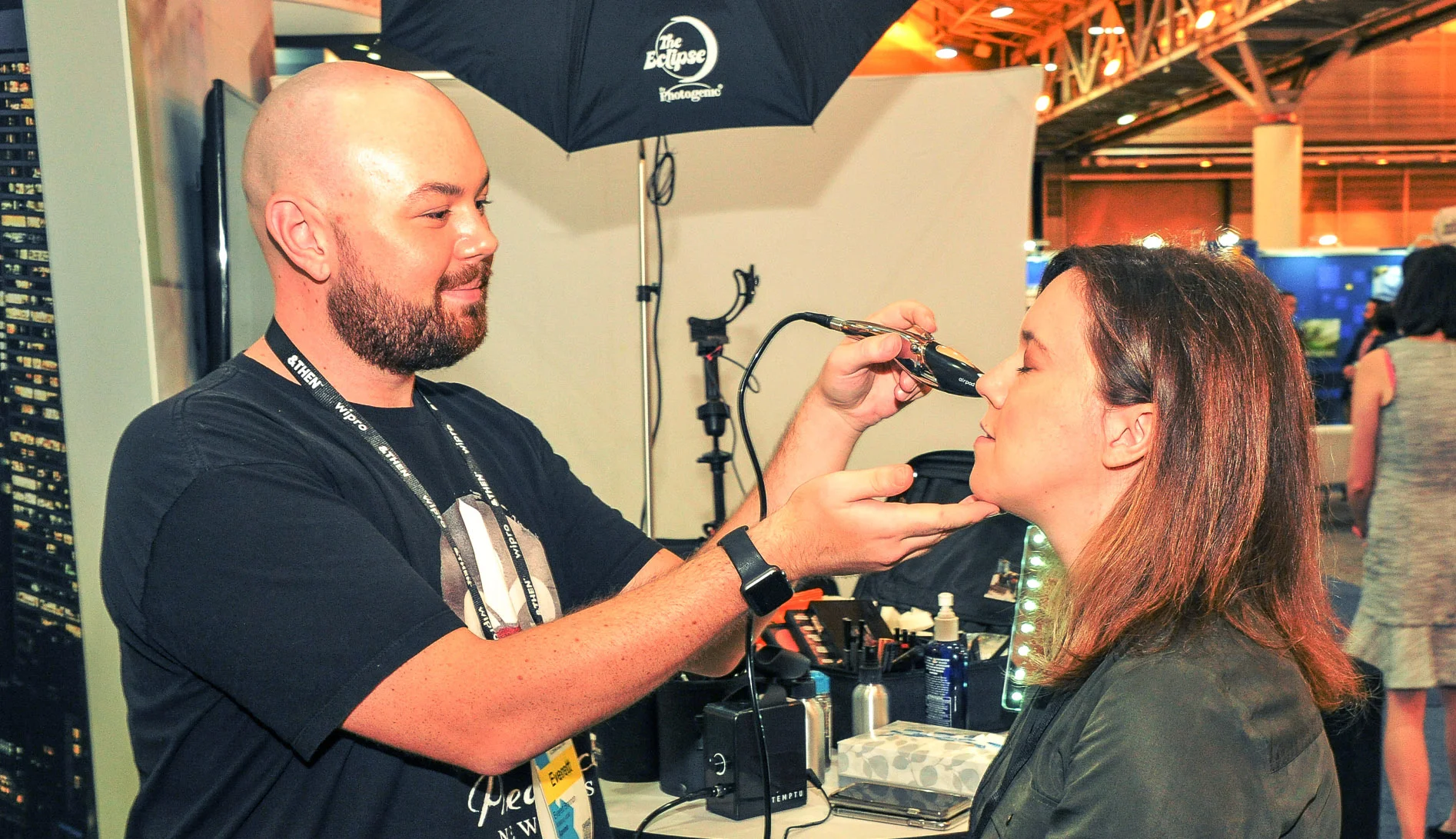 Airbrush foundation and touch-ups at the Aprimo Headshot Booth, photo by New Orleans Event Photography