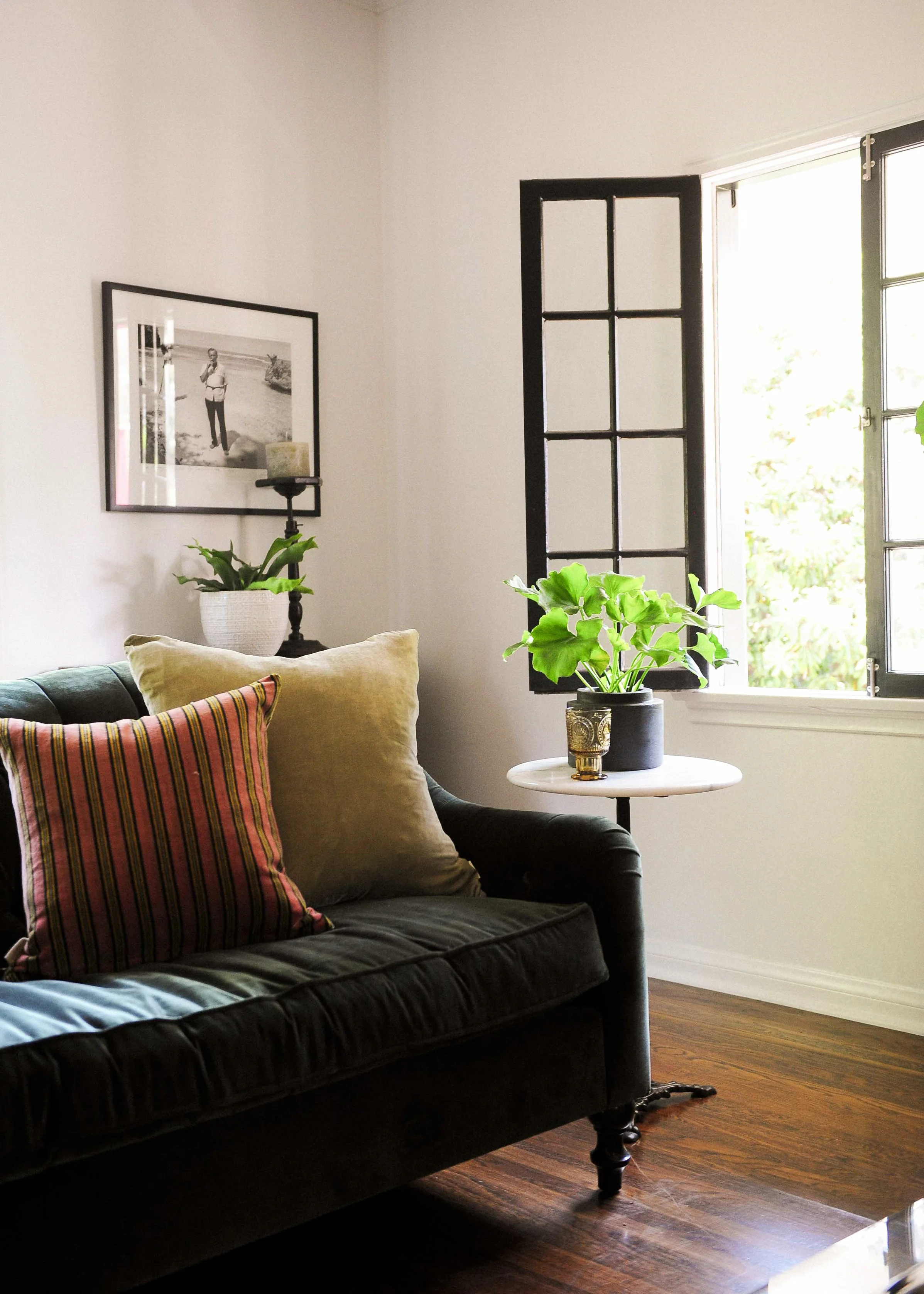 Items from Rolling Greens: pillows, antique marble side table with iron base, plants and containers.
