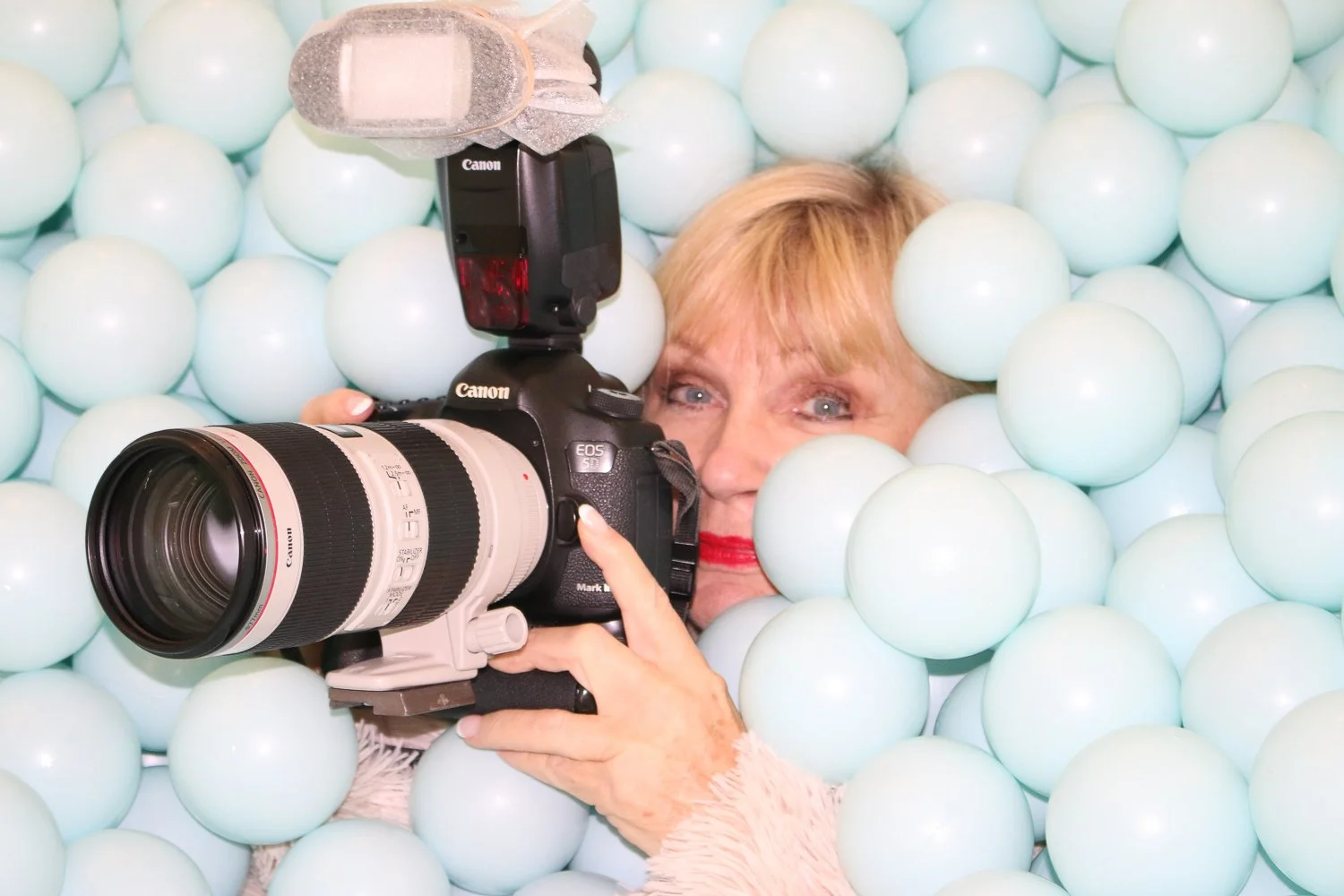 Lucille Khornak photographing with a professional camera