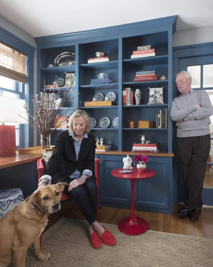 Leslie Condon plays with Patsy Cline in the study. Emily designed the built-in cabinetry, which is painted Benjamin Moore Blue Danube. A no-nonsense sisal rug adds texture.
