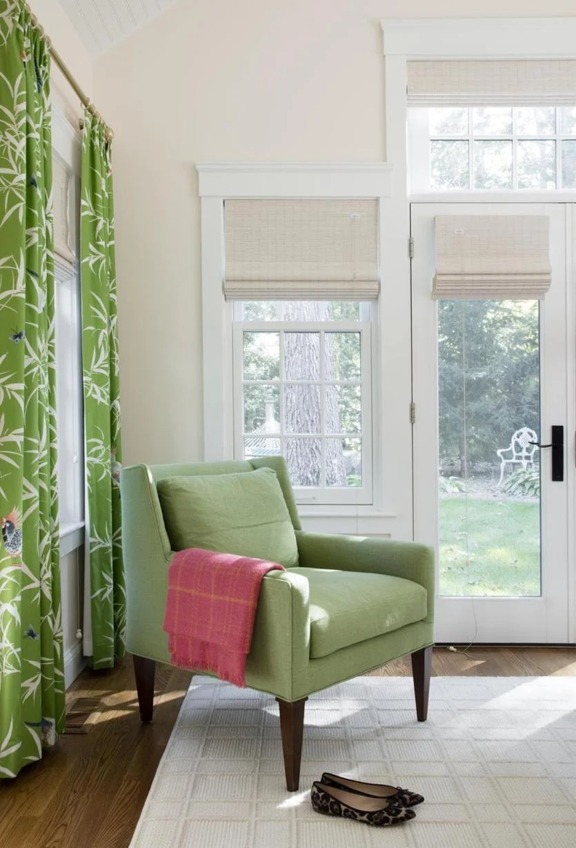 The master bedroom drapery fabric featuring tropical birds is Bamboo Grove from Bob Collins & Sons. “The neutral rug has a pattern that adds to the room, but not too much,” Emily says.