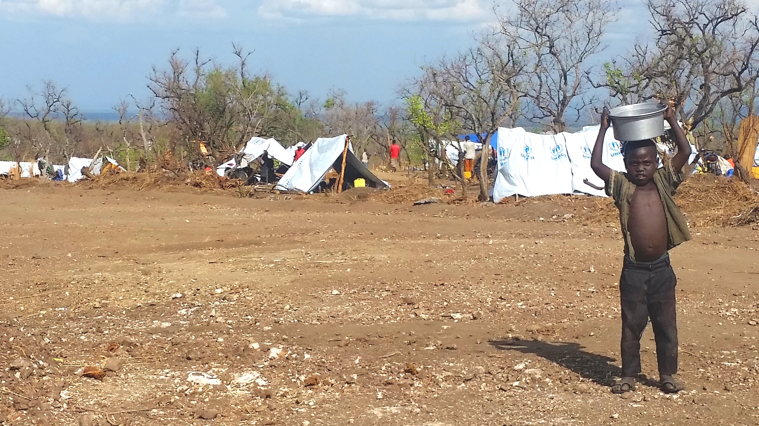  New “permanent homes” are erected for the South Sudanese refugees. Most are coming across the border with nothing but the clothes on their backs. These tarp tents are meant to protect them from all the elements: rain, wind, and soaring African heat.