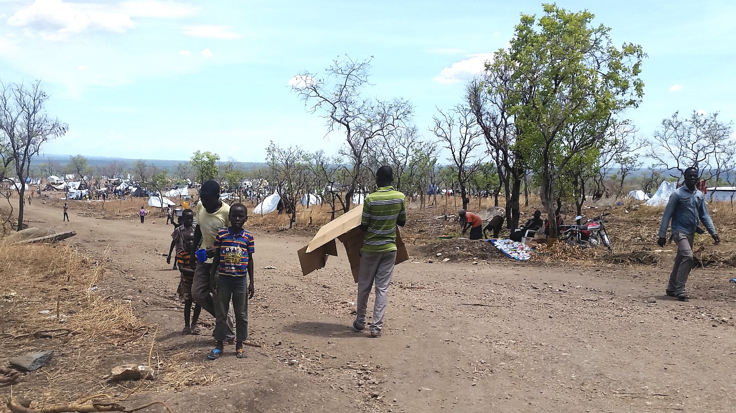  Refugees walk the dusty roads at Invepi Camp in northern Uganda. 