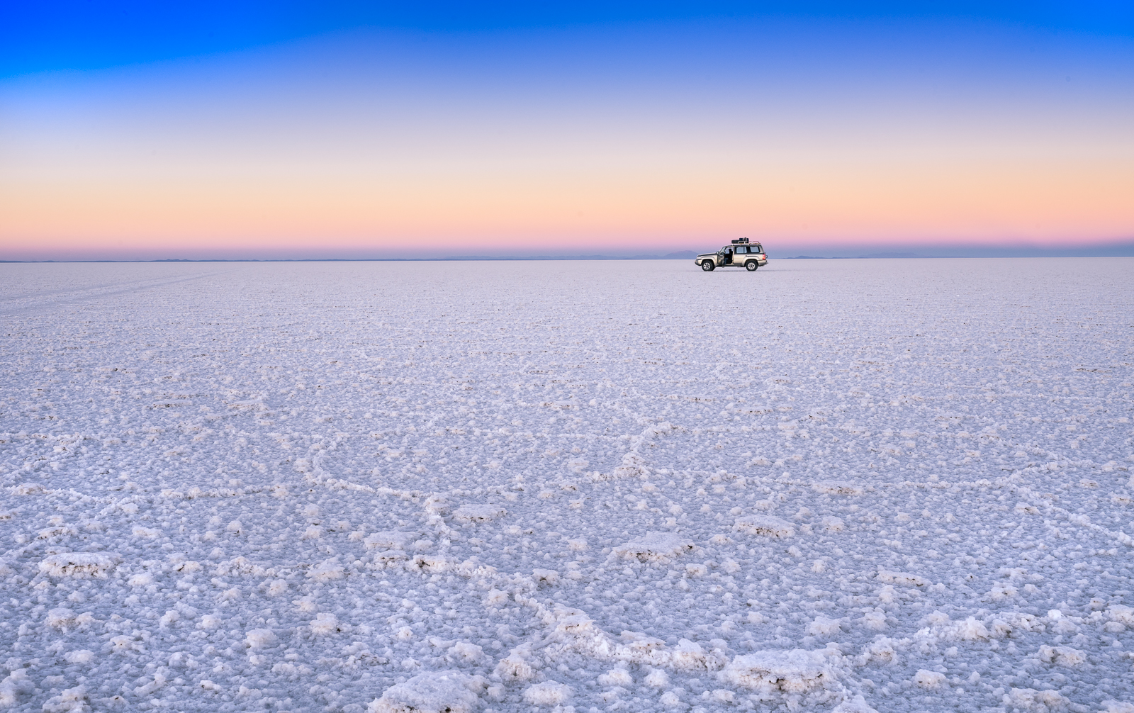 The salt flats at Salar de Uyuni during sunset.