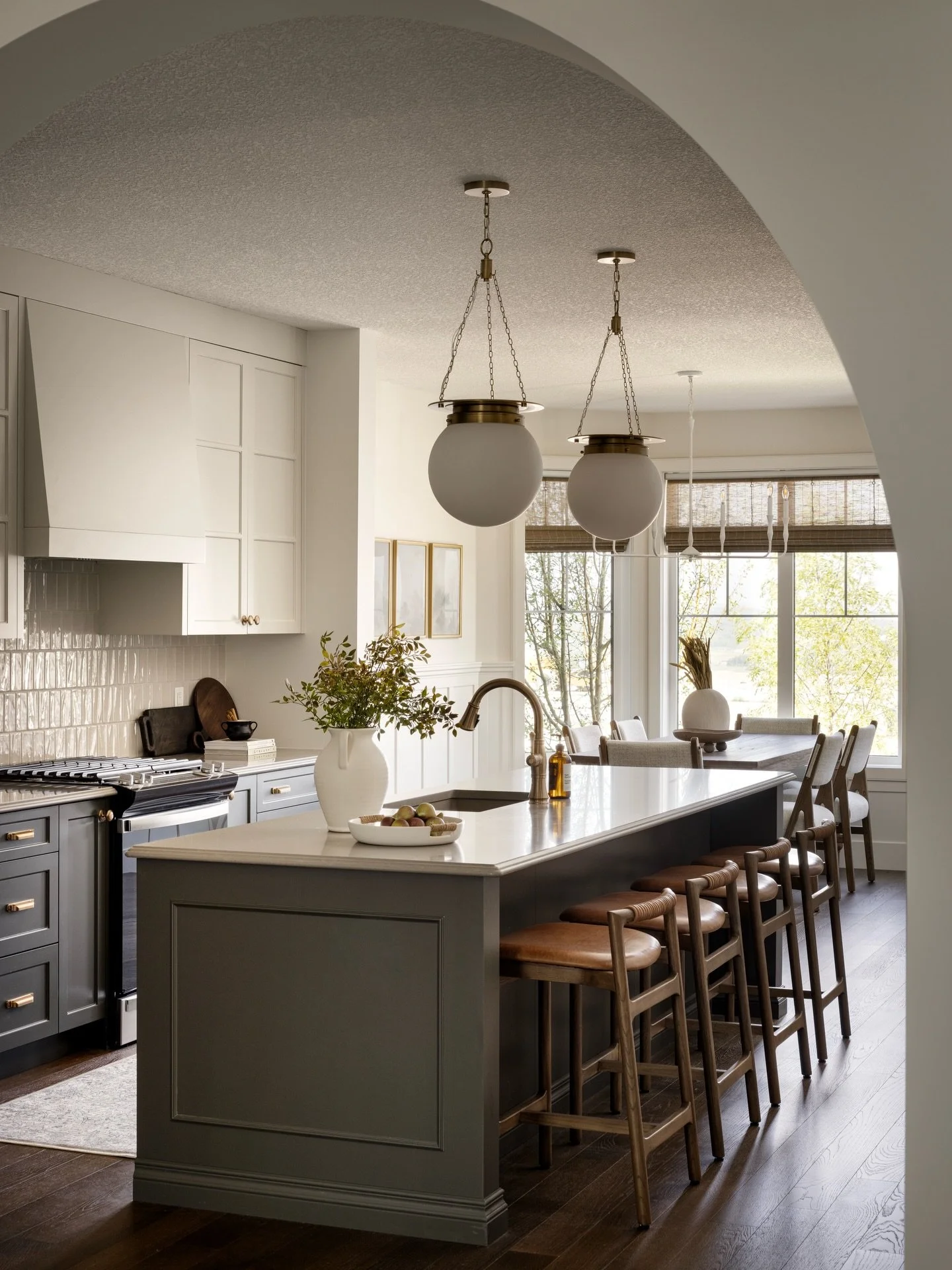 Contrast is key to a clear design! In this kitchen, the darker base cabinets ground the space while the lighter upper cabinetry adds a sense of airiness. This subtle contrast defines areas in the open concept space without disrupting the flow.