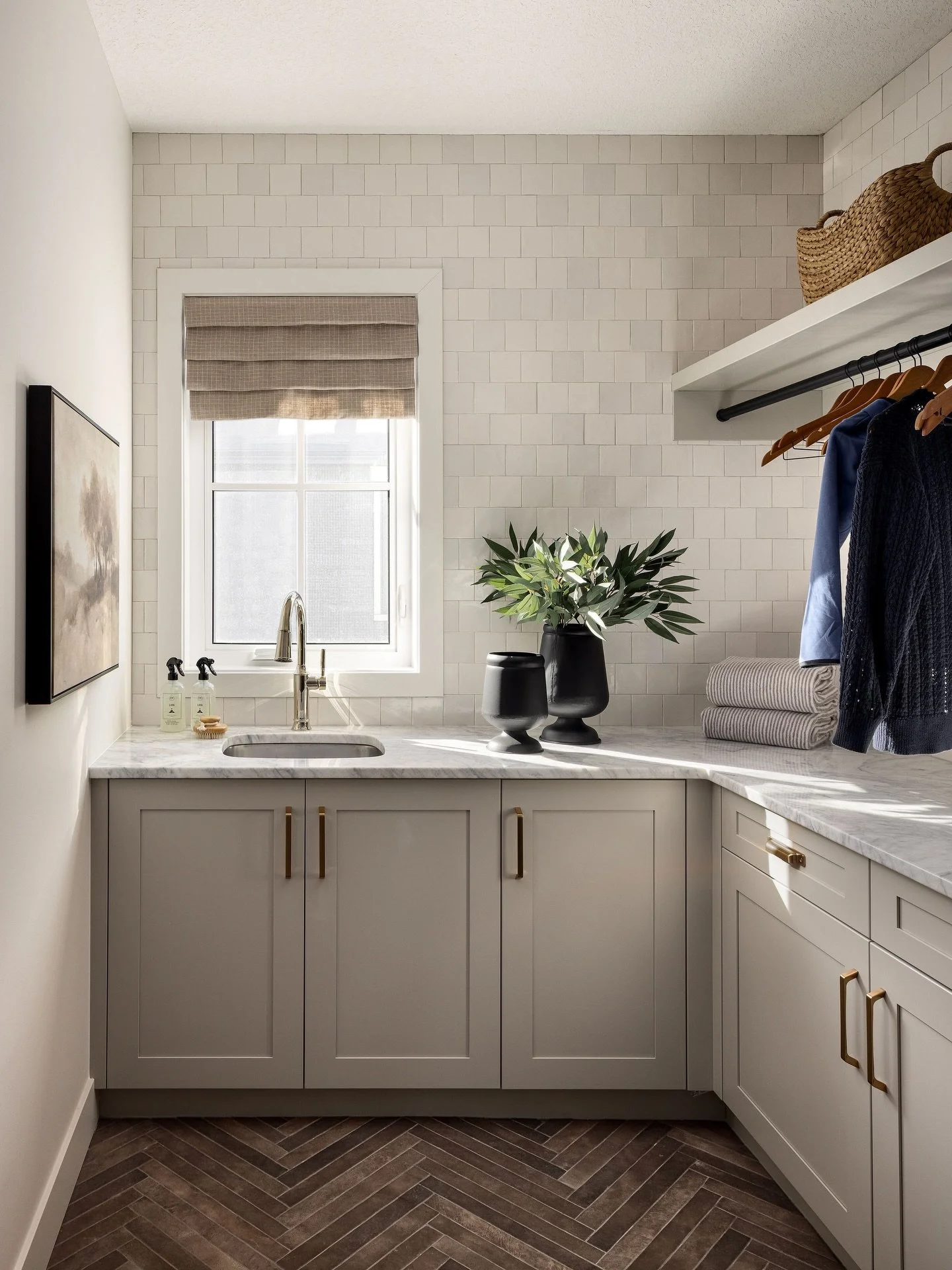Even the smaller spaces of your home deserve attention!!

Thinking about how materials work together is key. In this laundry room it&rsquo;s a combination of soft cabinetry tones, brass accents, and the double herringbone tile install on the floor. N