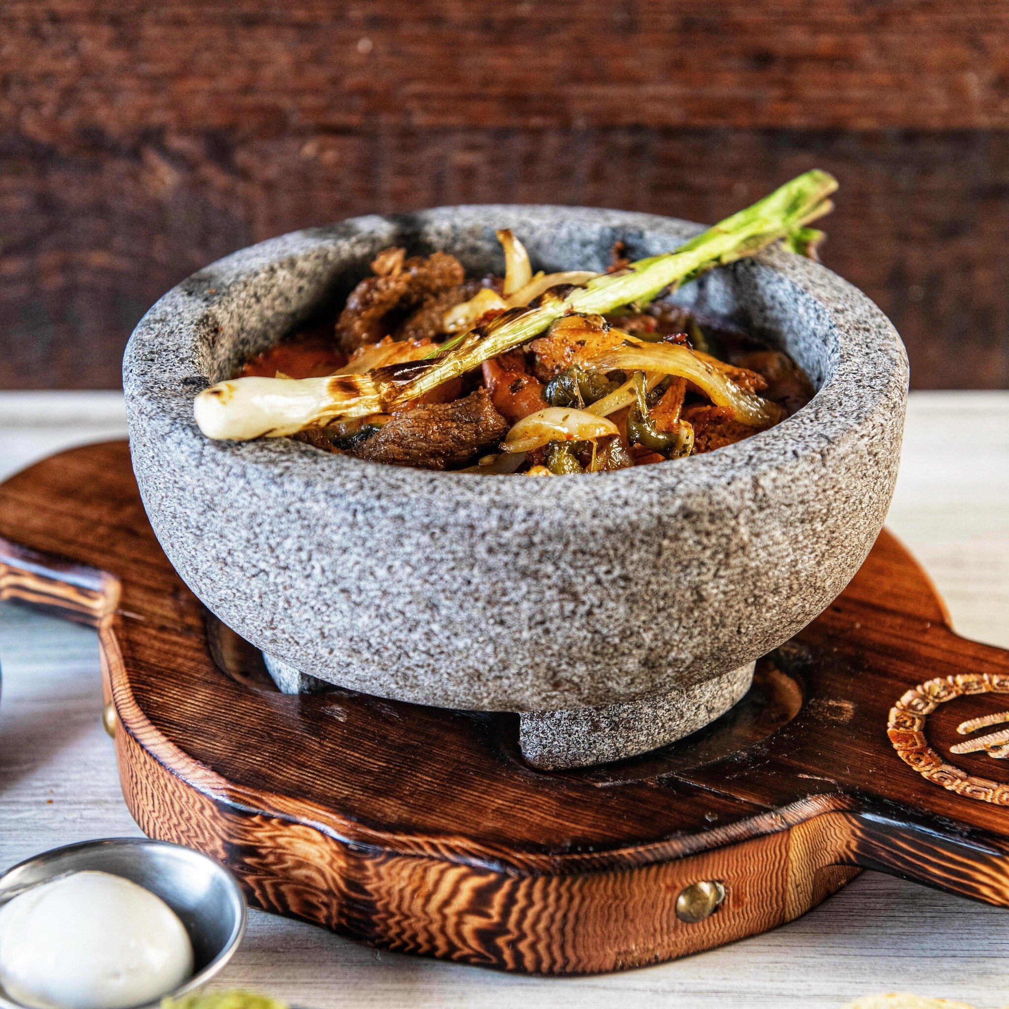 Elevate your Easter feast with the rich and vibrant flavors of our Molcajete Mixto. An authentic Mexican spicy stew made with your choice of meat,combined with poblano peppers, onions, chorizo, green onions, and cheese served sizzling in a traditiona