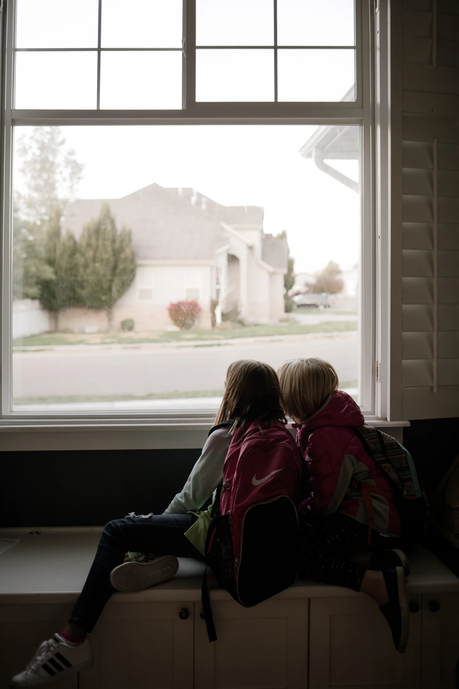 This image is of my daughter and her friend Summer waiting for their carpool. I just loved the soft cool morning light. This window is usually blown out completely when I shoot near it, so I liked how you could really see out to the road and the neighborhood. It also shows their little friendship that is strong and volatile, like sisters.